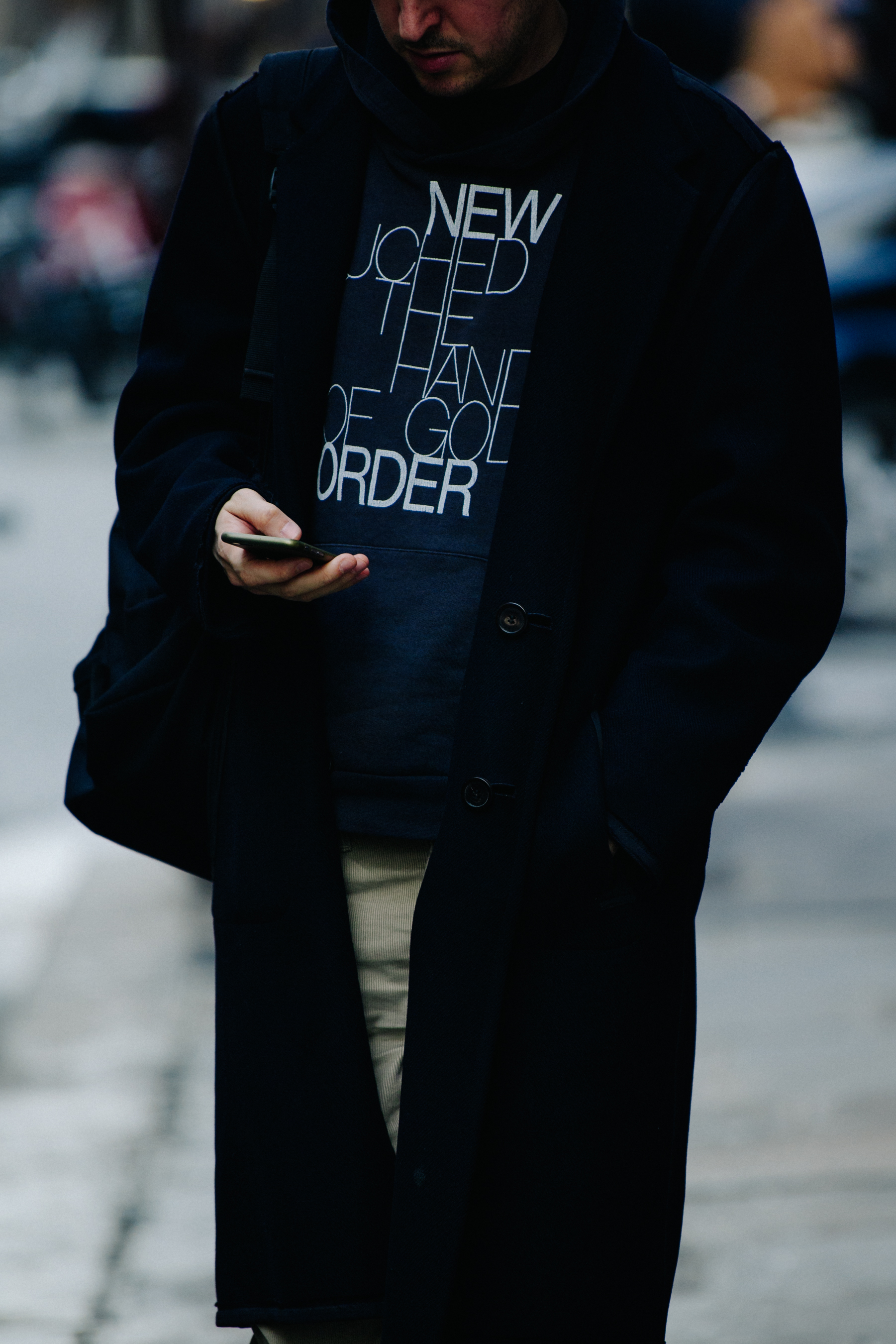 Man wearing long black wool coat