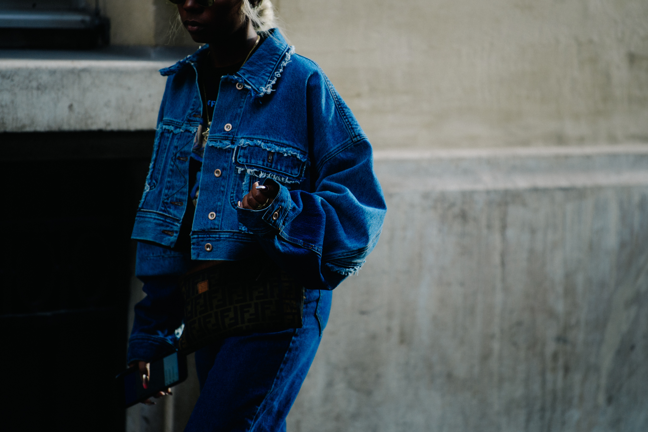 Girl wearing frayed denim jacket