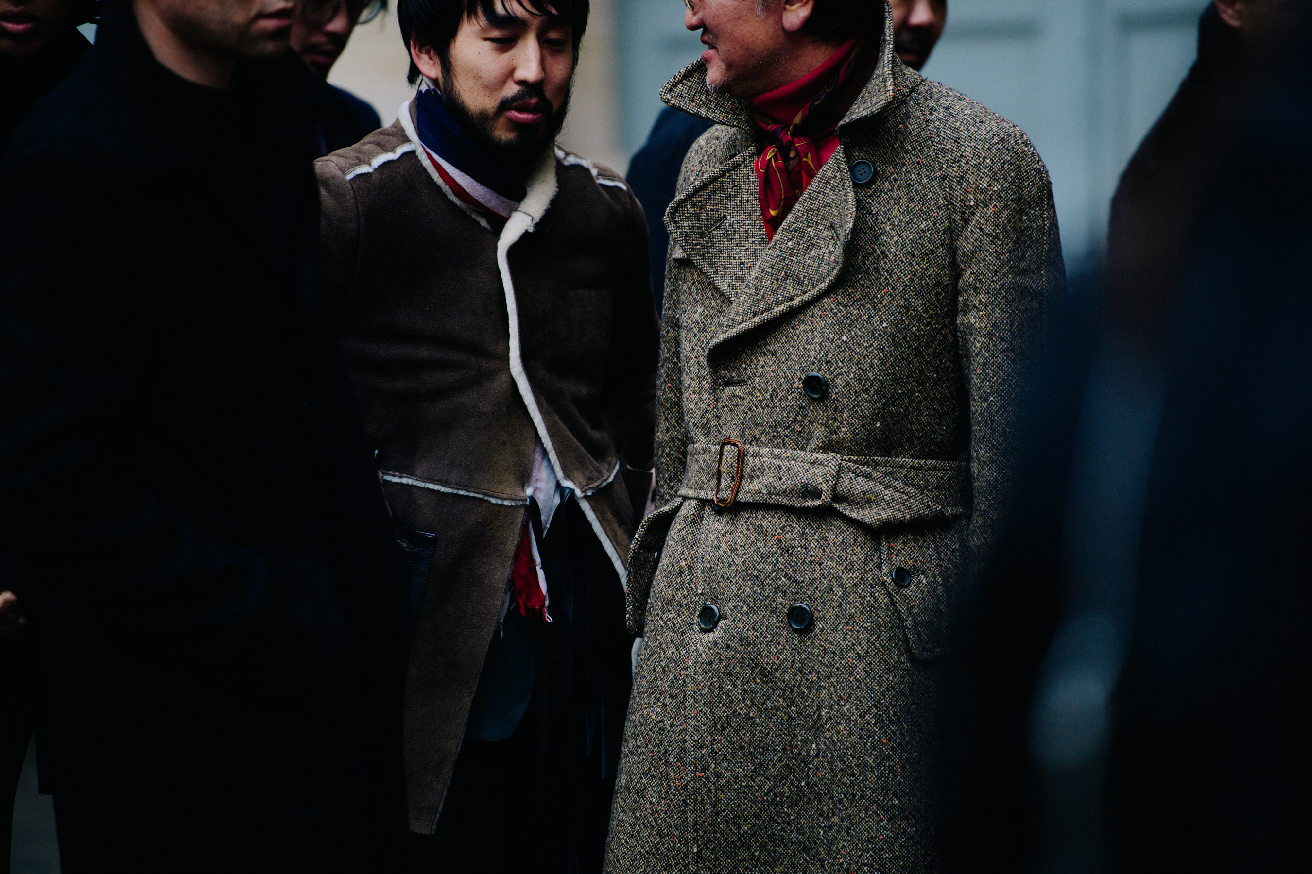 Two Asian men wearing brown coats