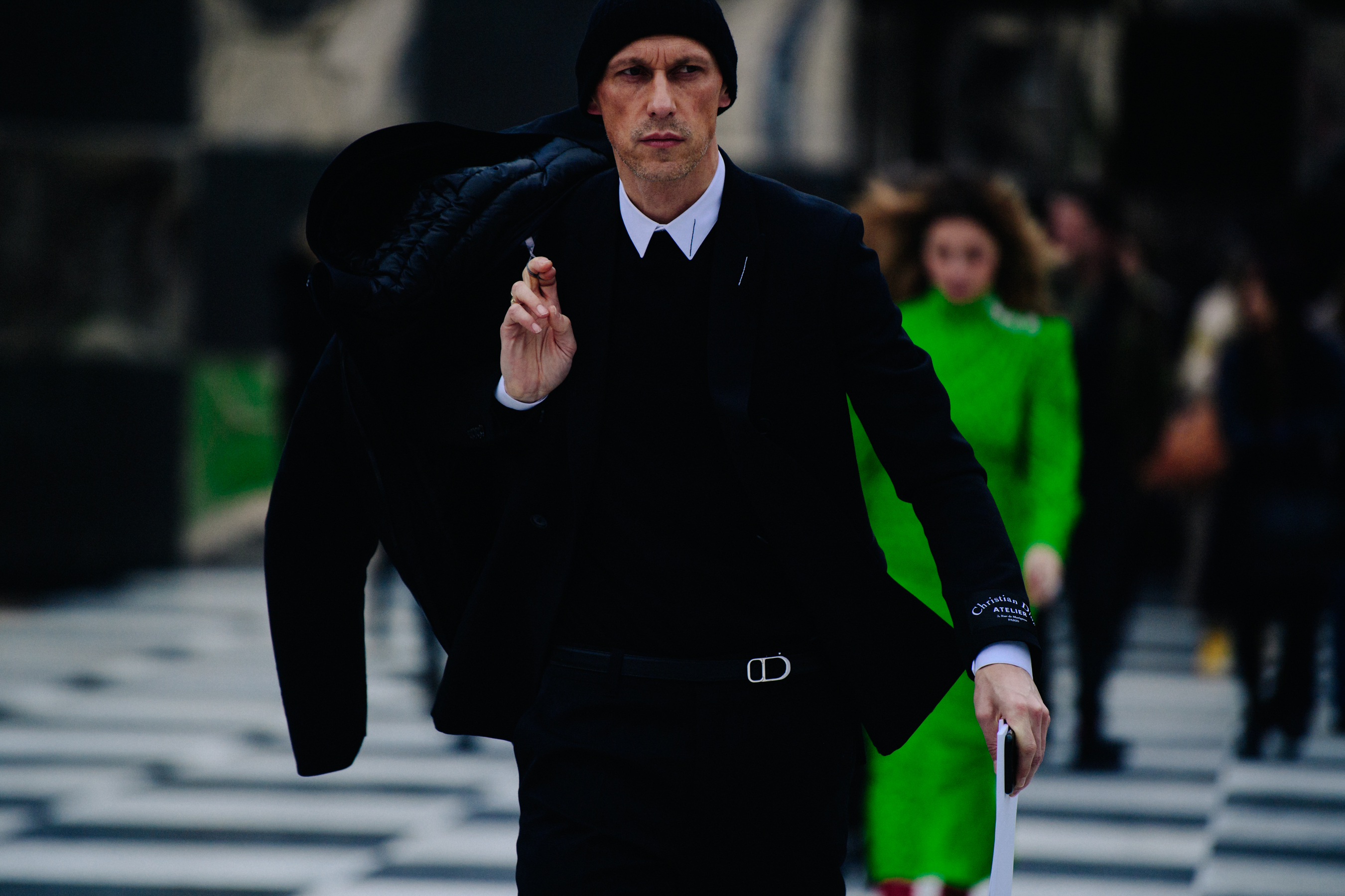 Man wearing black suit and beanie