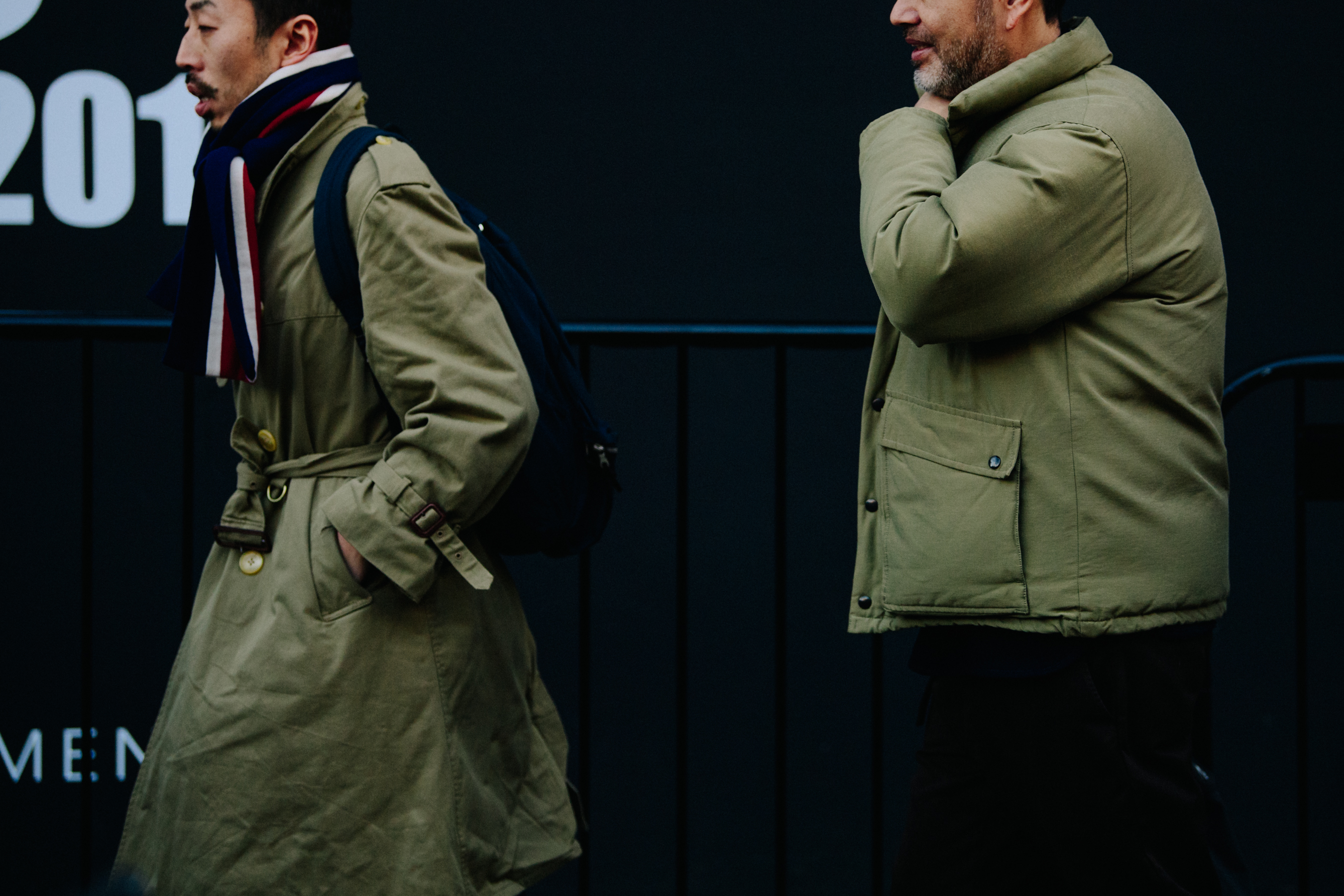 Two men wearing khaki jackets
