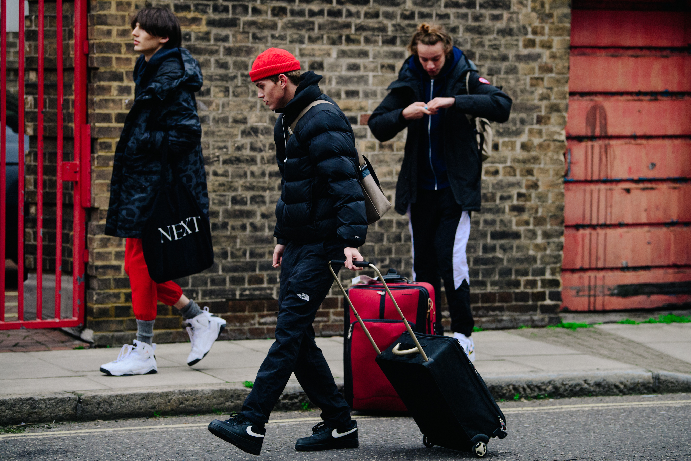 Models leaving show with luggage