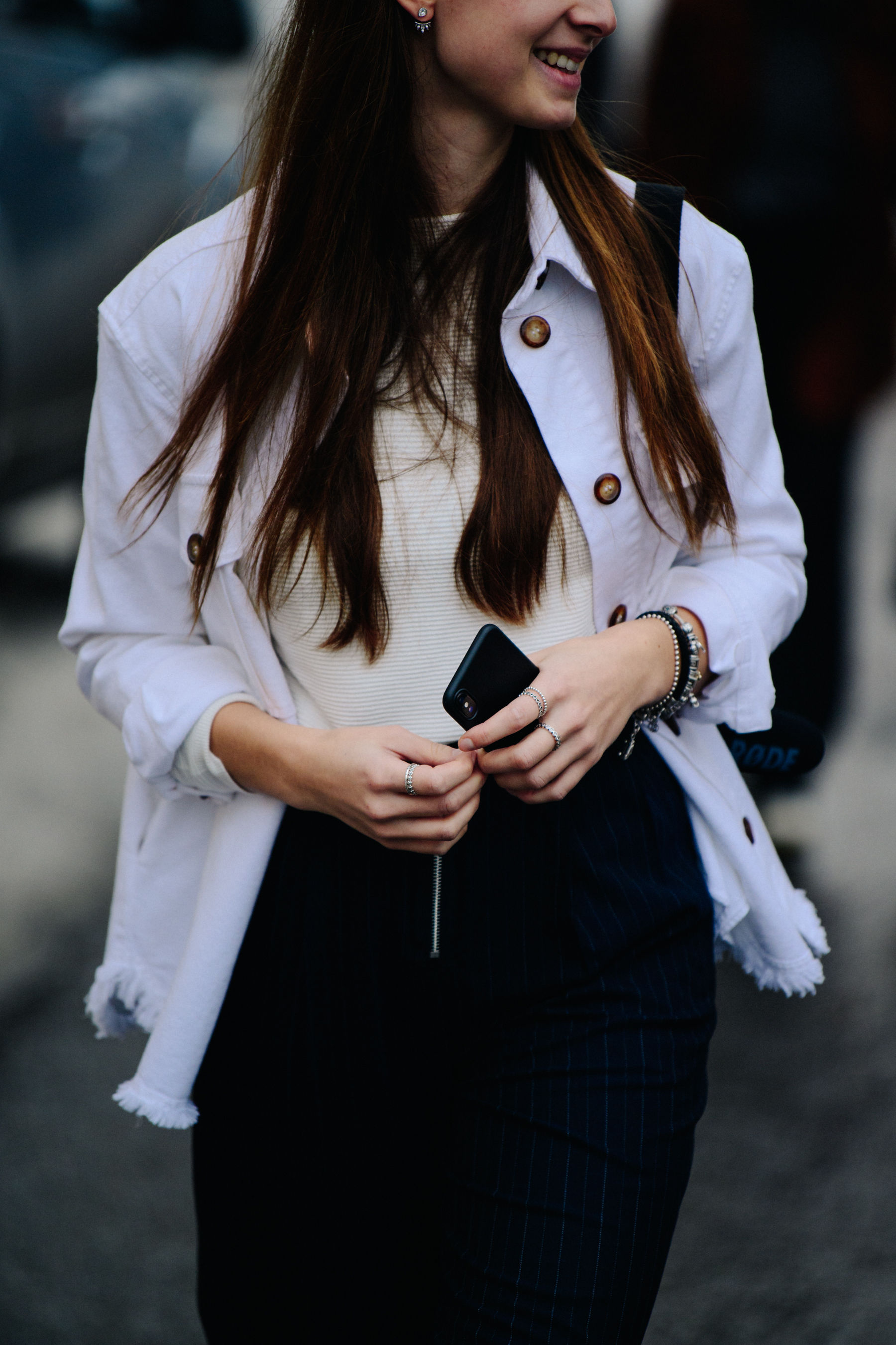 Woman wearing white frayed jacket