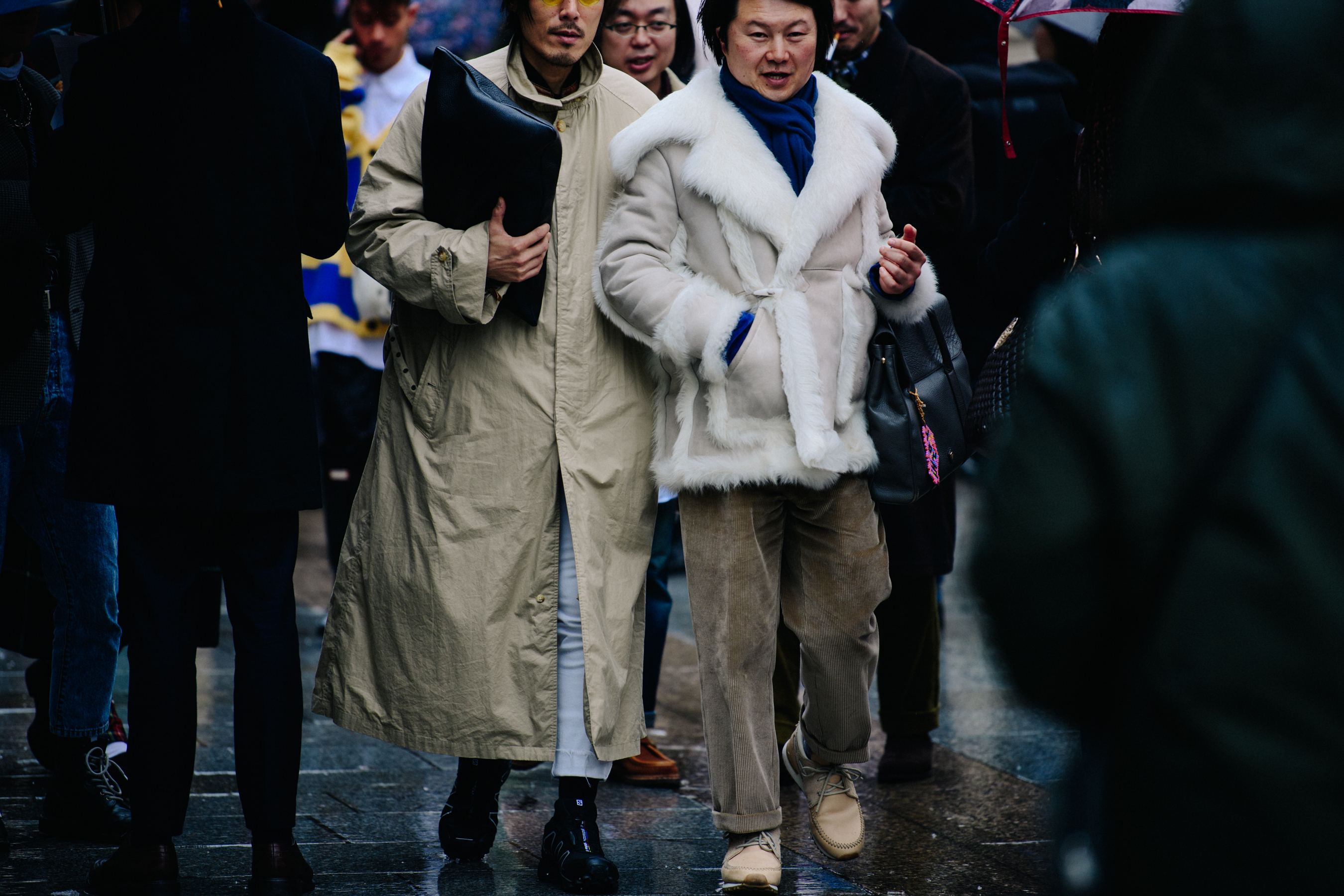 Two Asian men wearing pale outfits
