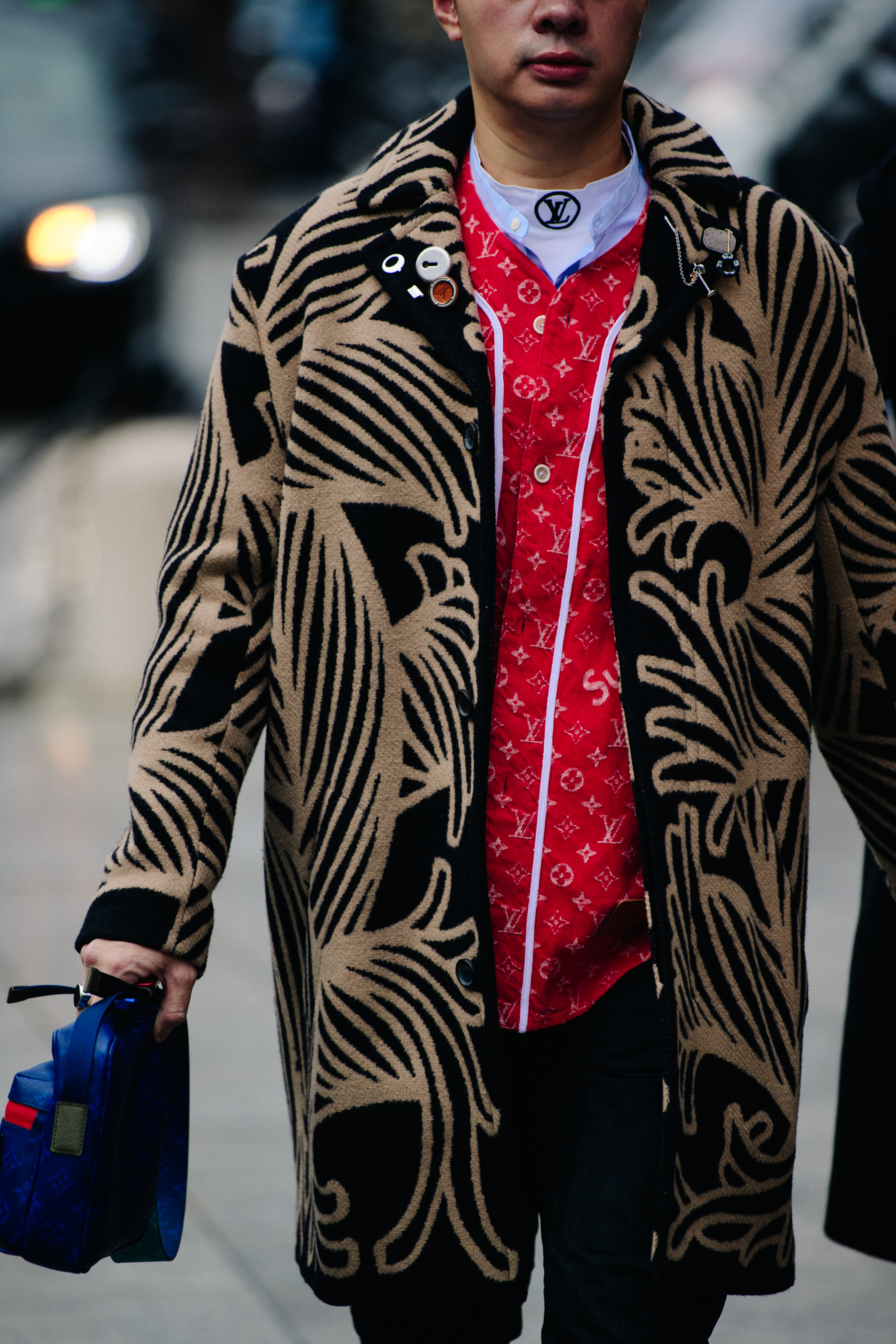 Man wearing red Louis Vuitton x Supreme jacket