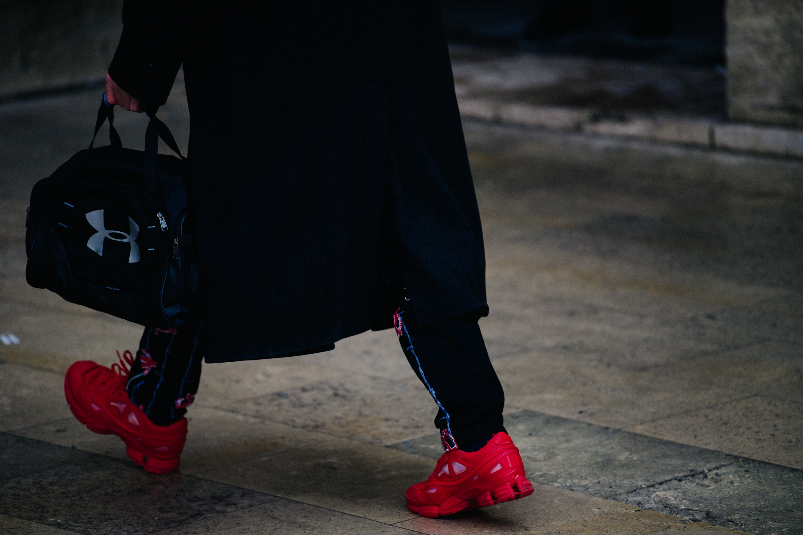 Man wearing red Raf Simons sneakers