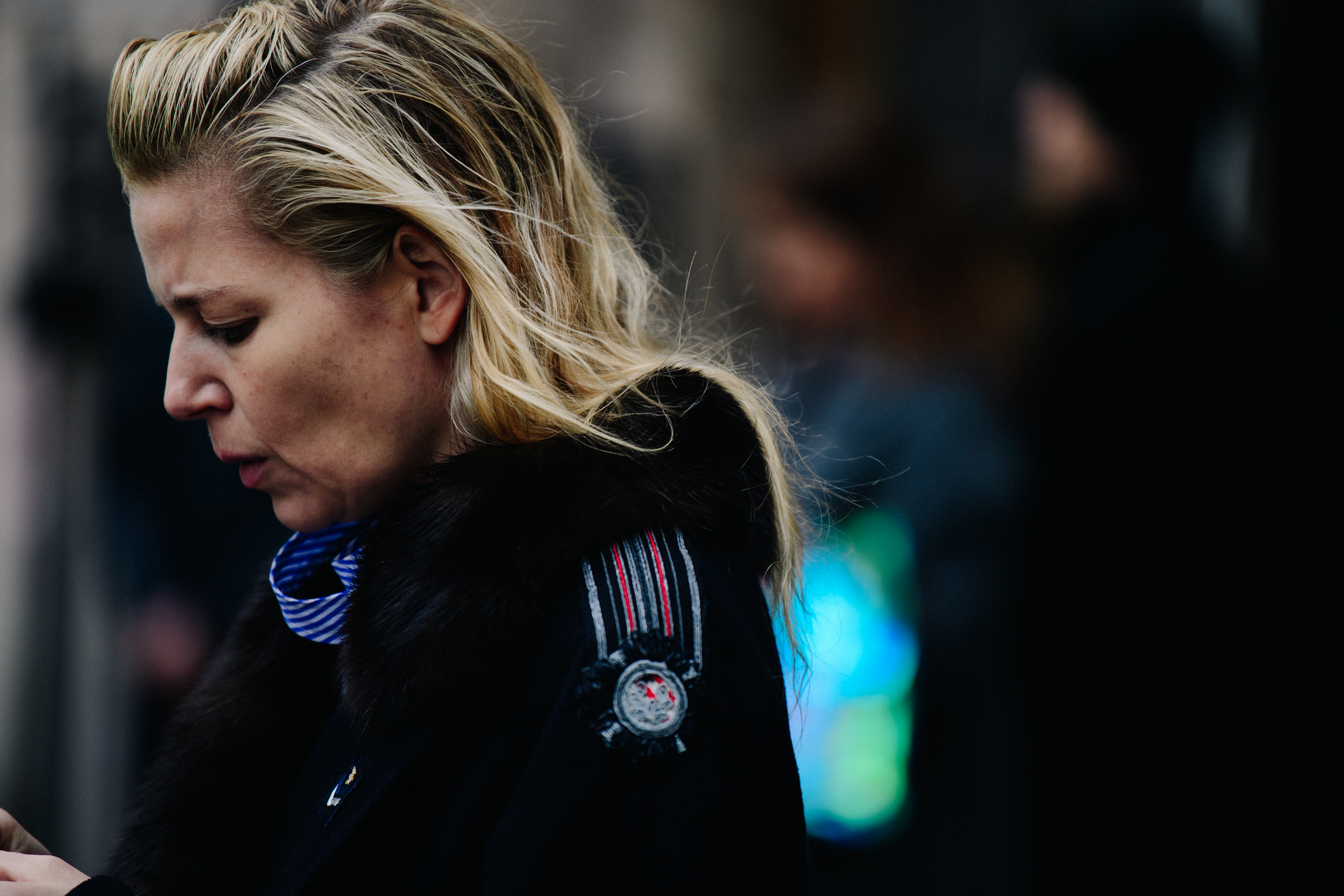 Woman wearing black fur trim coat