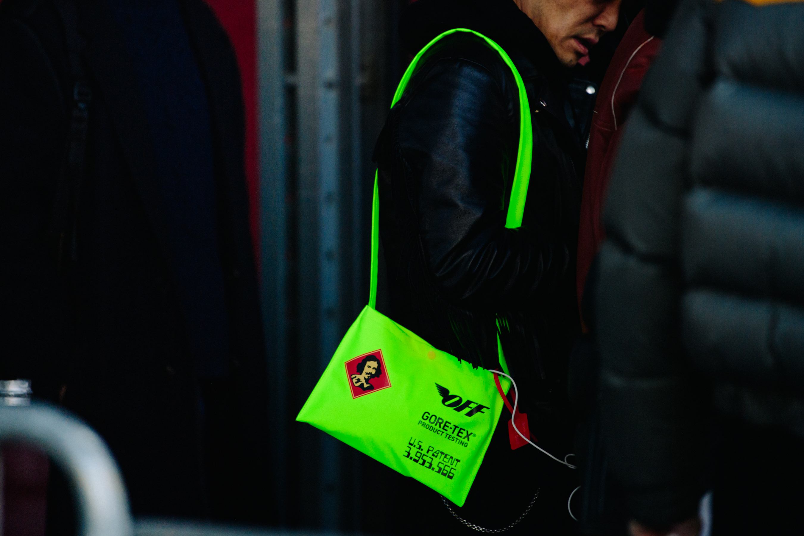Man wearing green Off-White bag