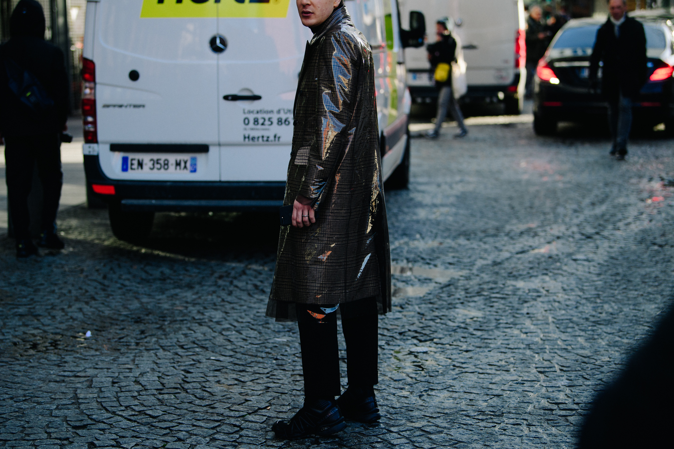 Man wearing long plastic coat