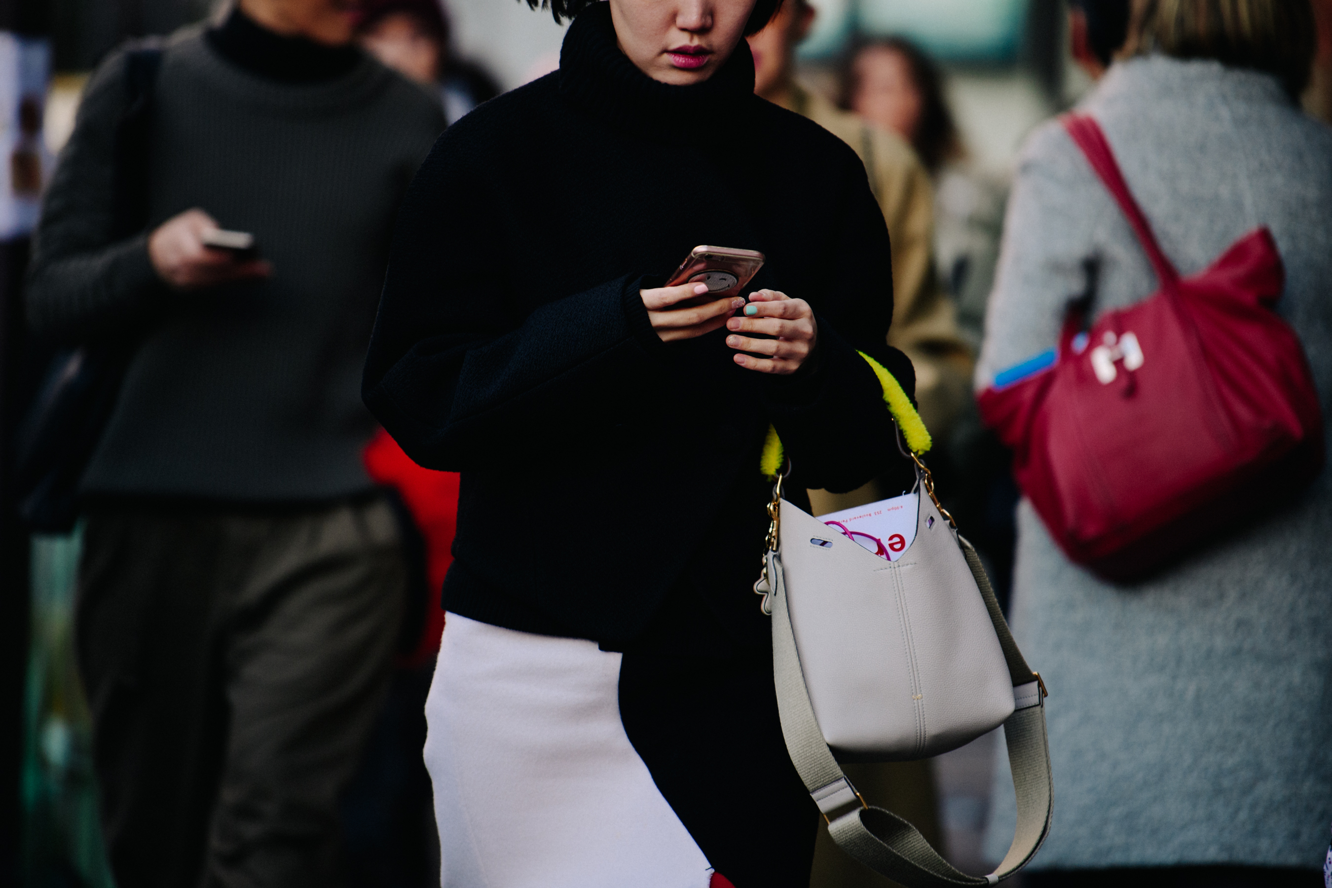 Woman holding cream leather bag