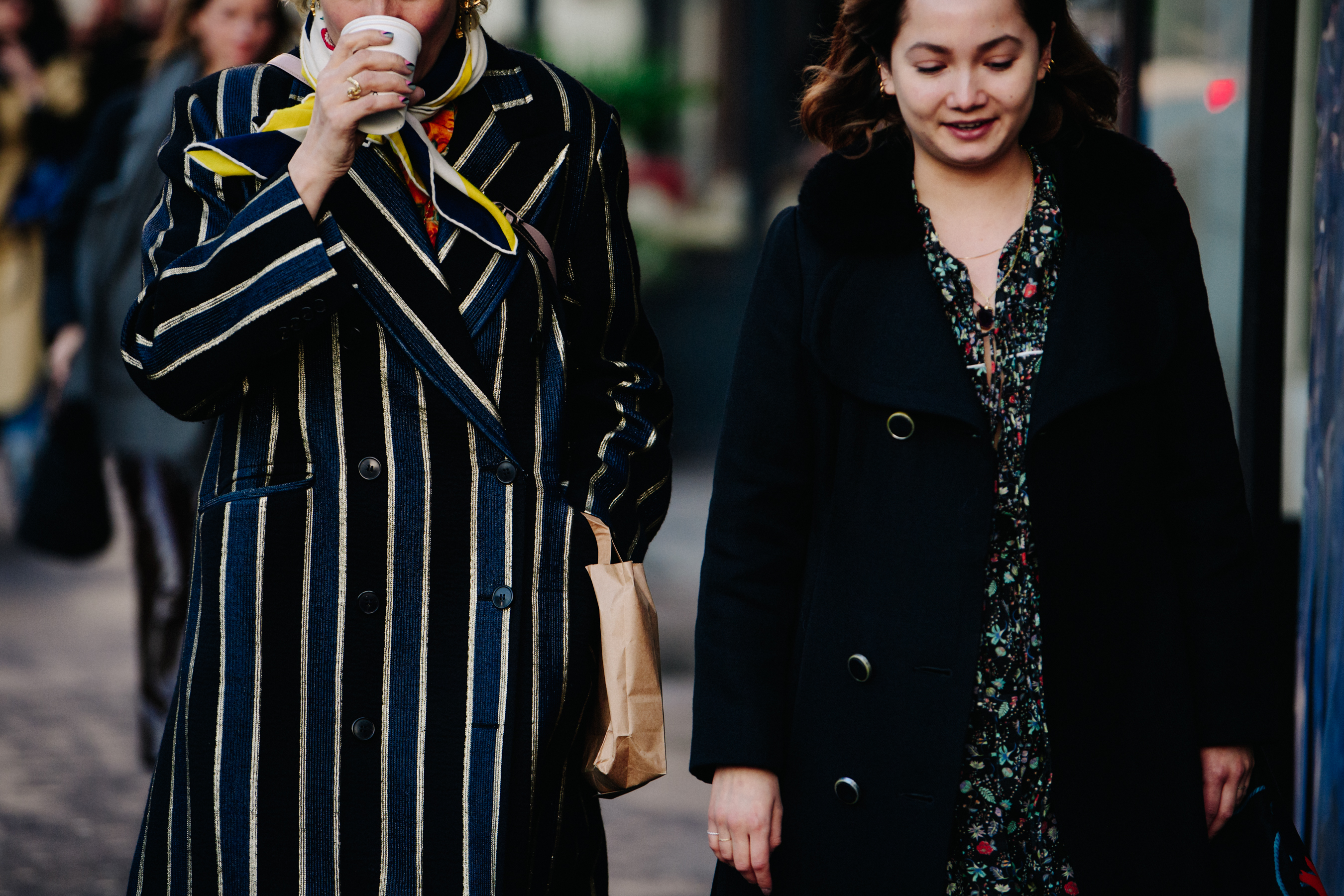 Two women wearing black coats