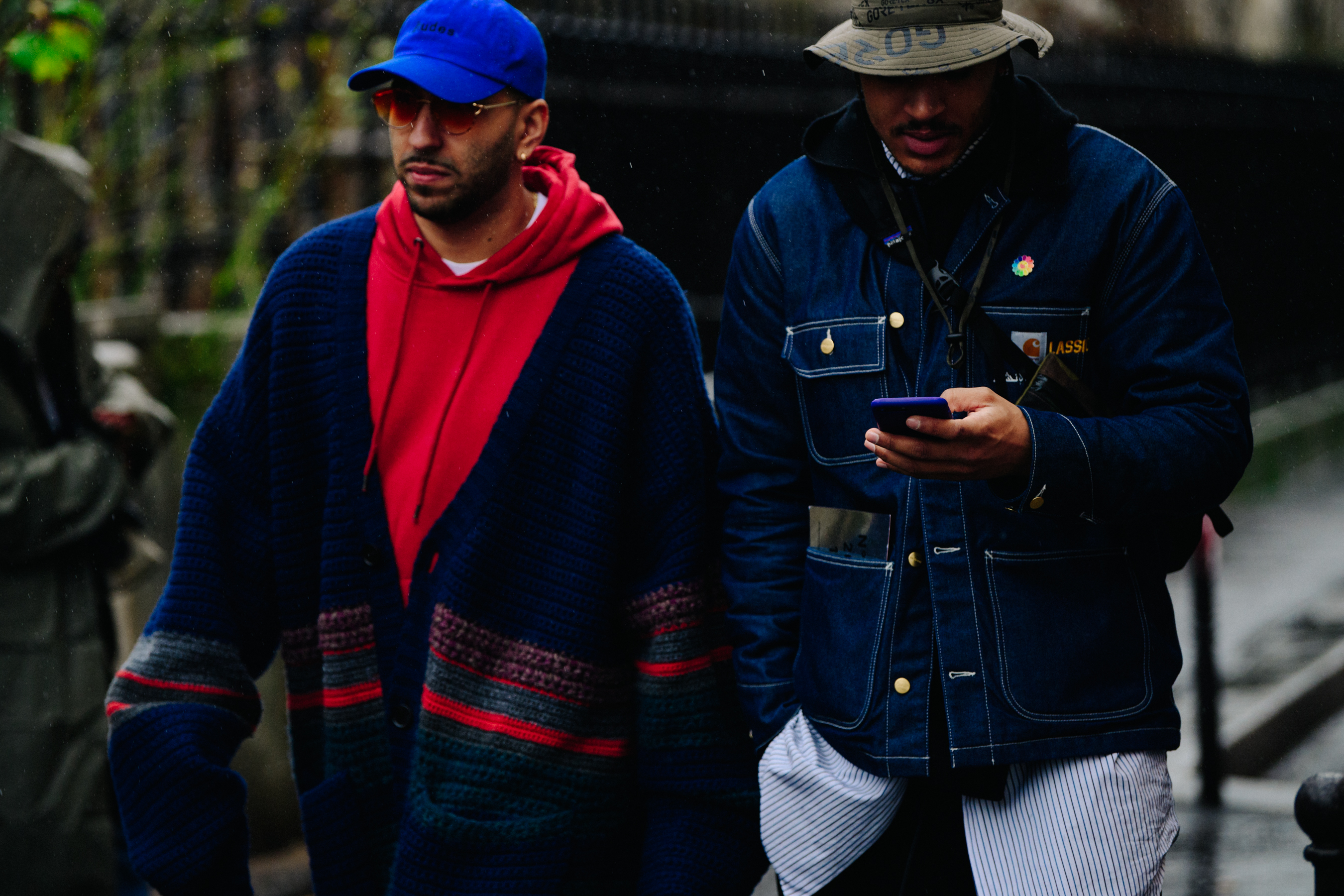 Two men wearing hats in the rain
