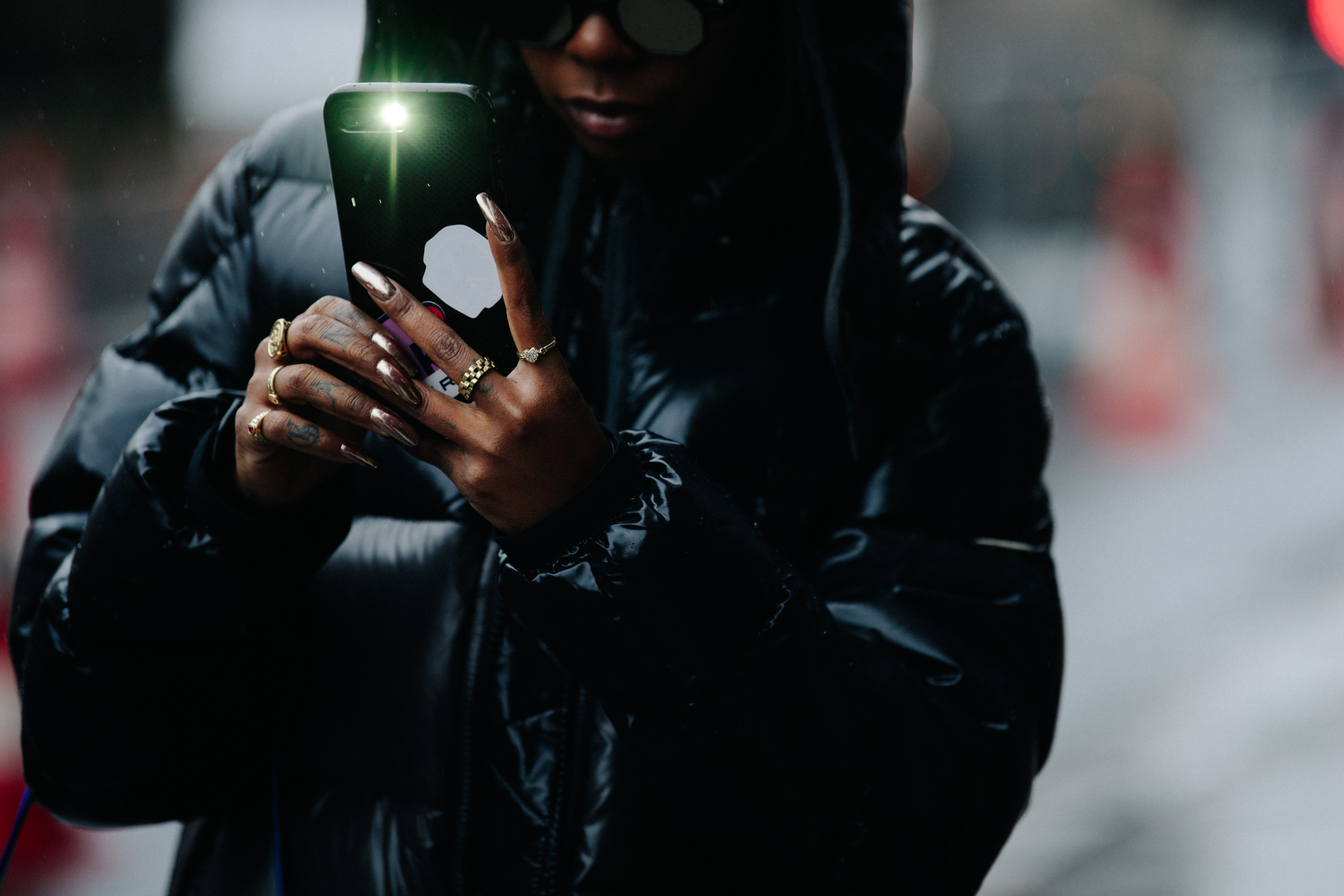 Woman using iPhone camera flash