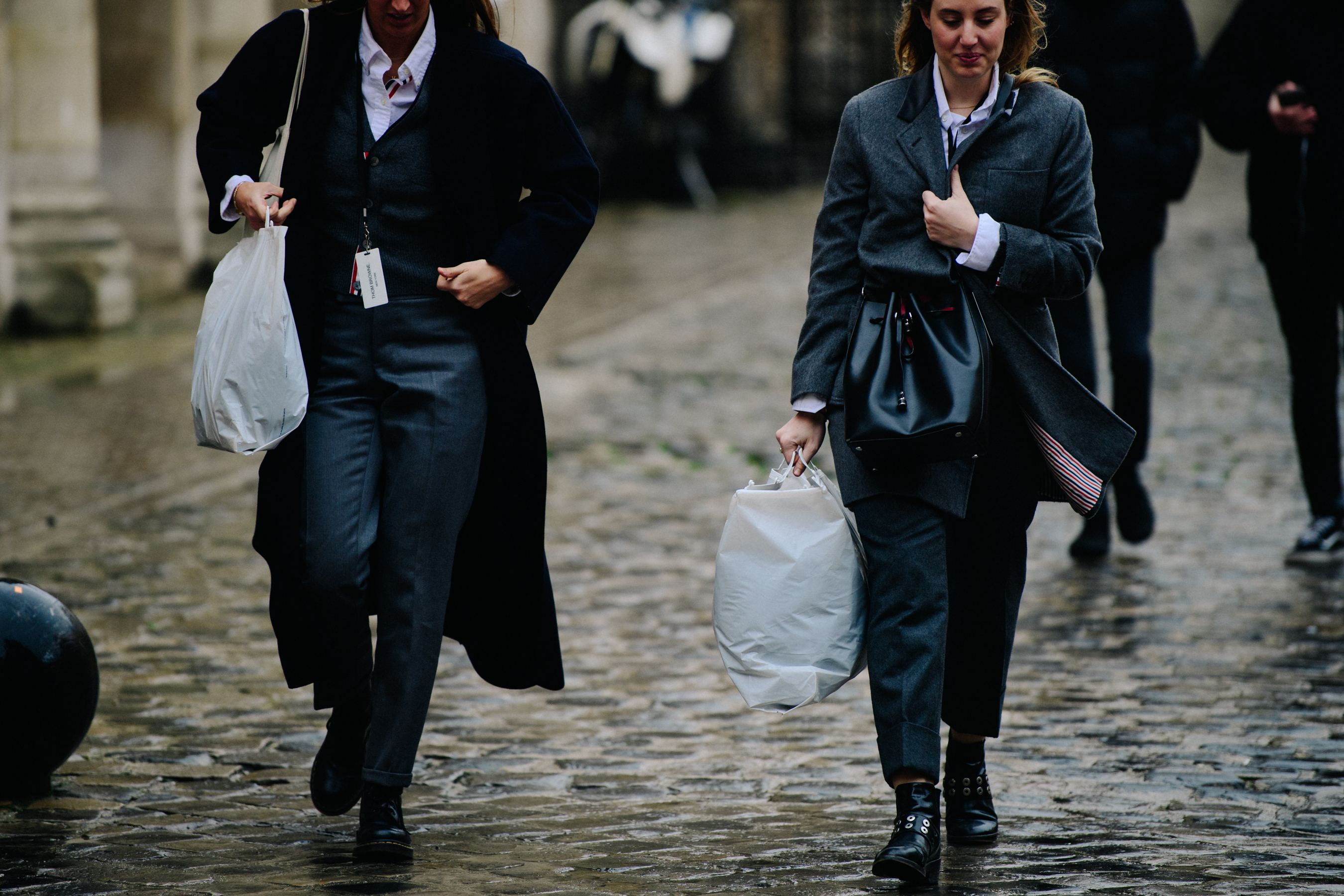 Two women wearing Thom Browne suits