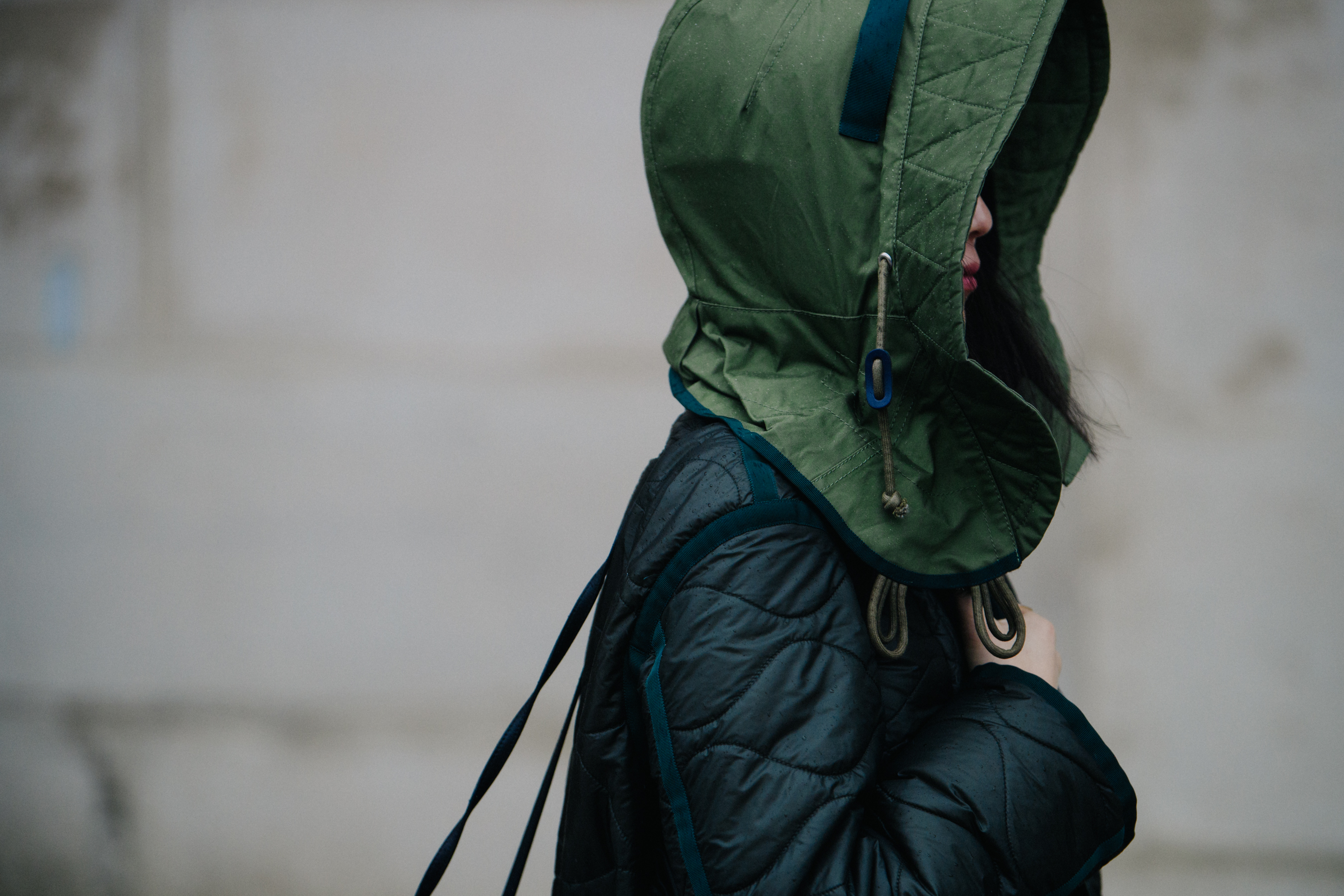 Woman wearing big green hood
