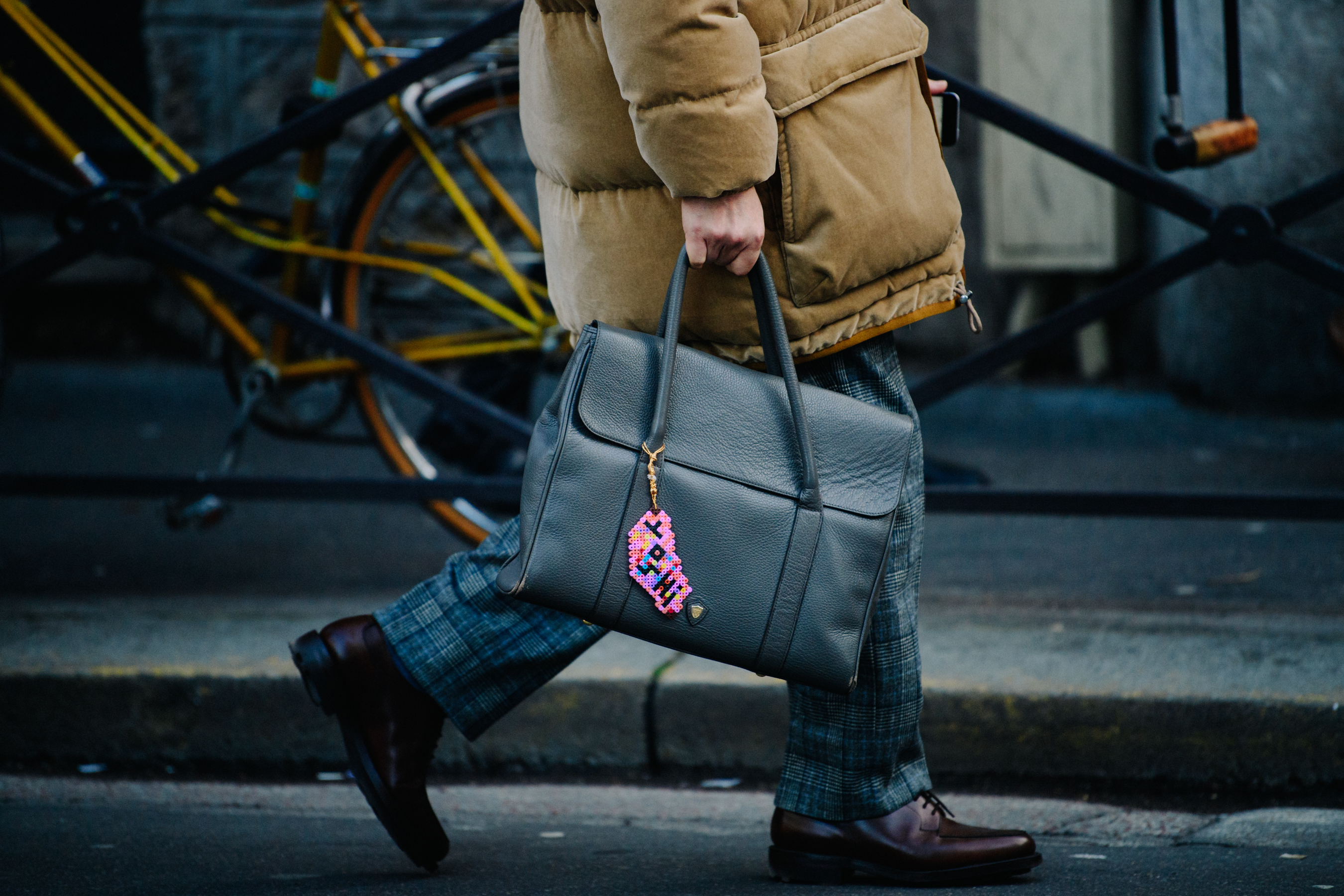 Man carrying bag with pink keychain