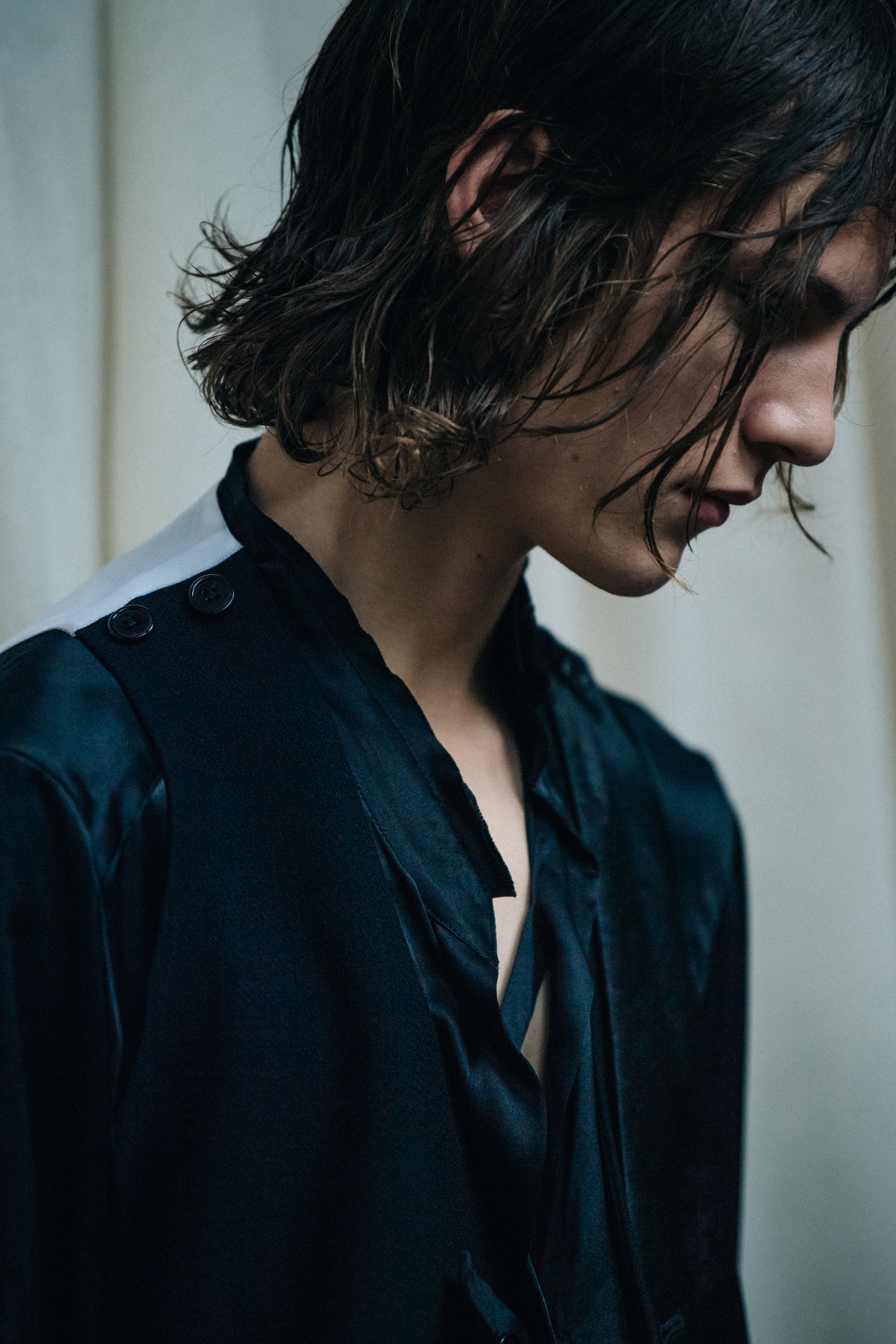 Model wearing black suit backstage