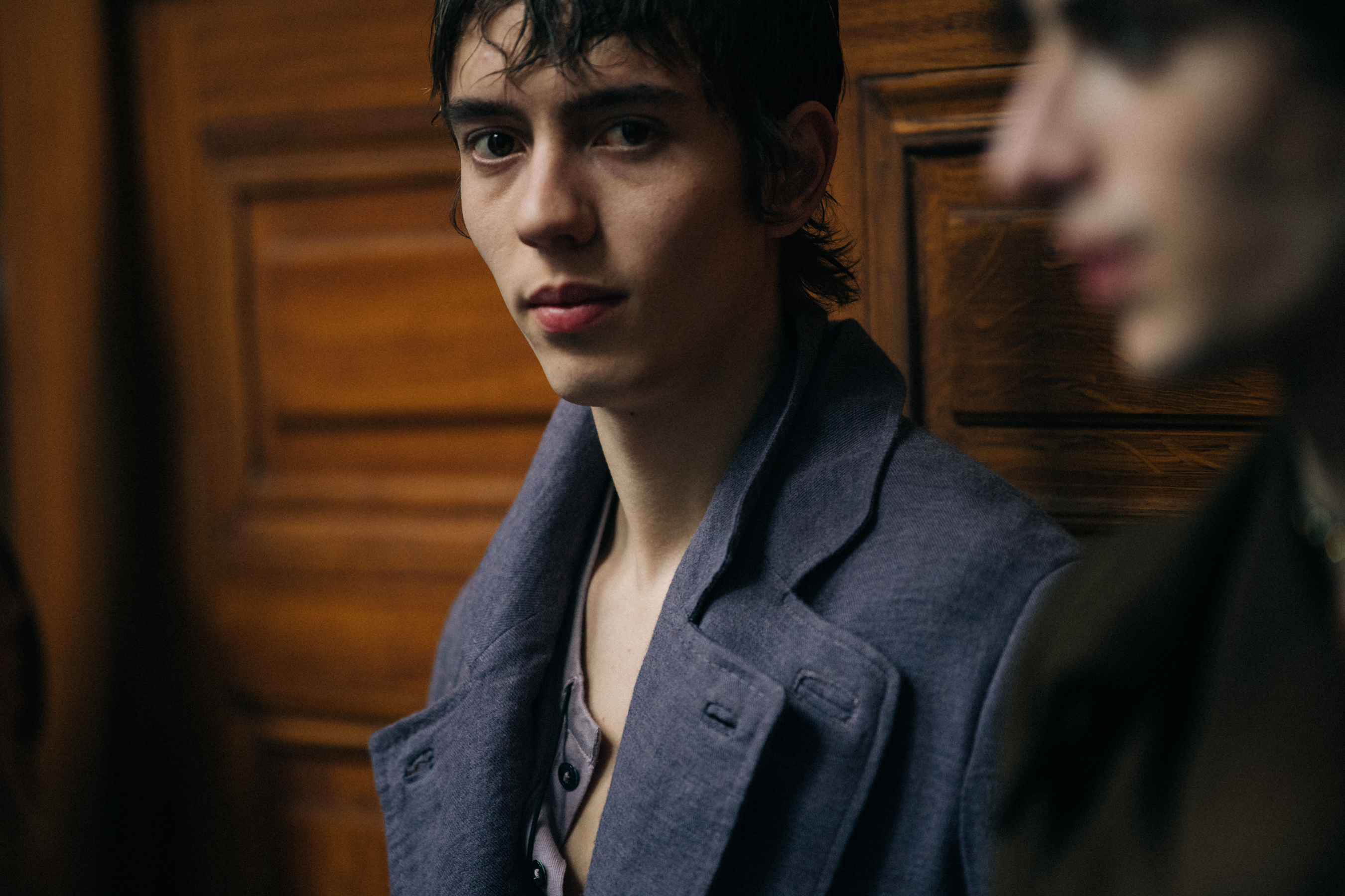 Wim Koch backstage wearing purple jacket