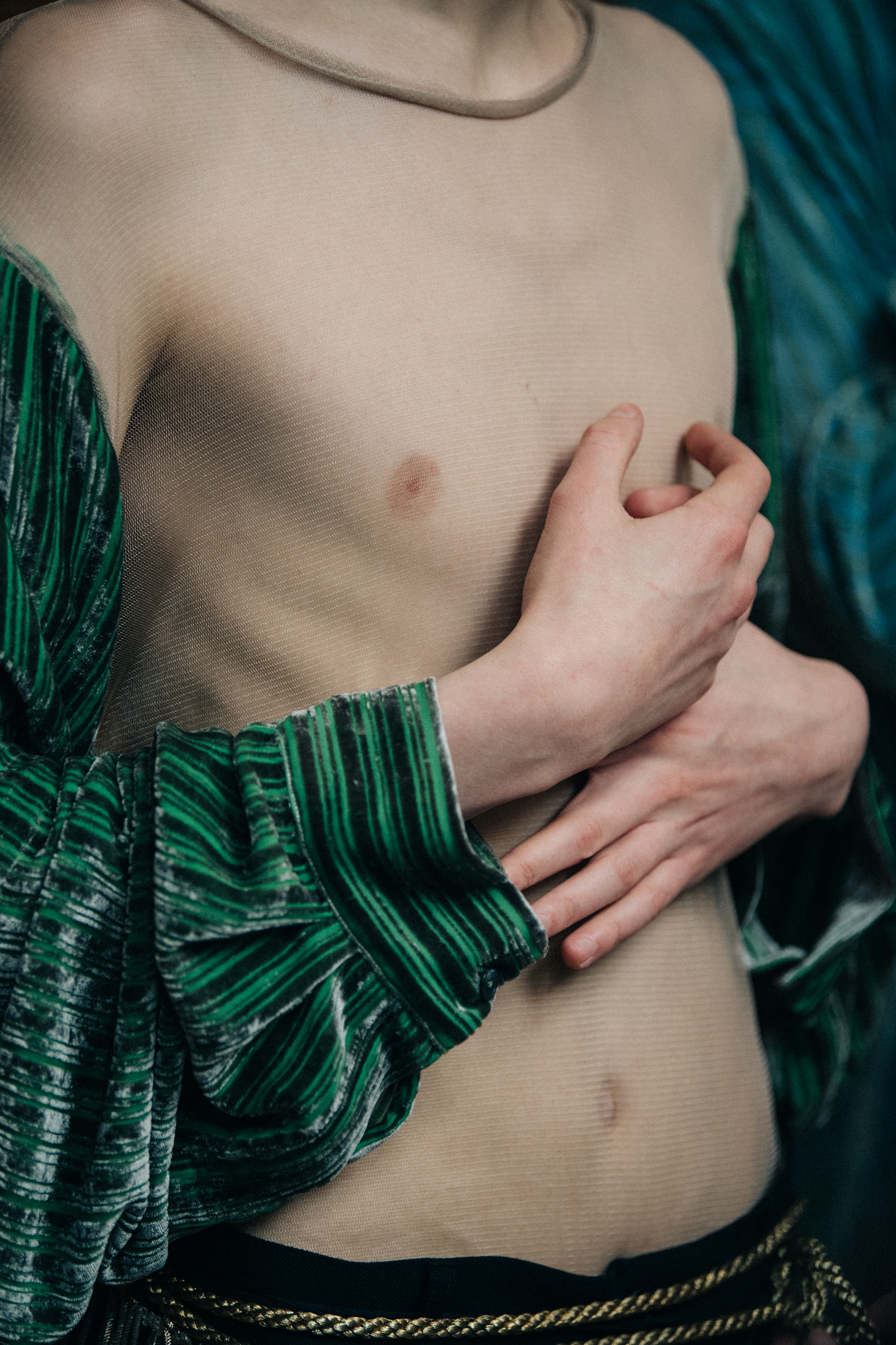Model wearing green sleeves backstage