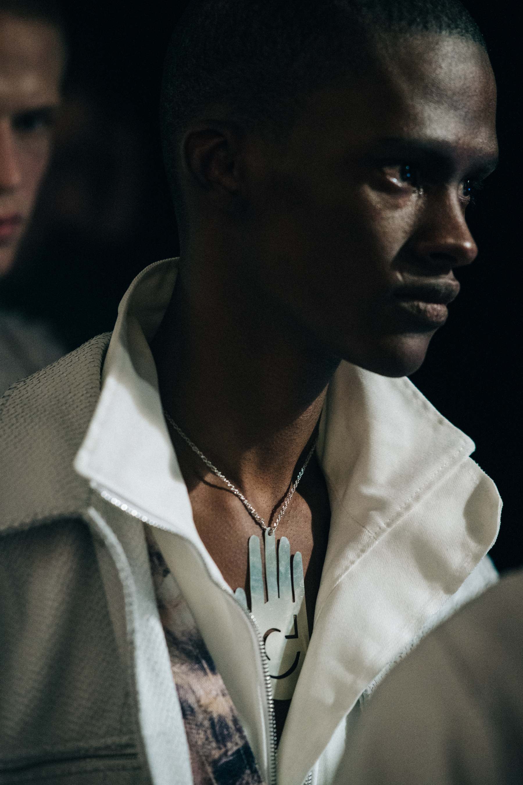 Model wearing white collared jacket