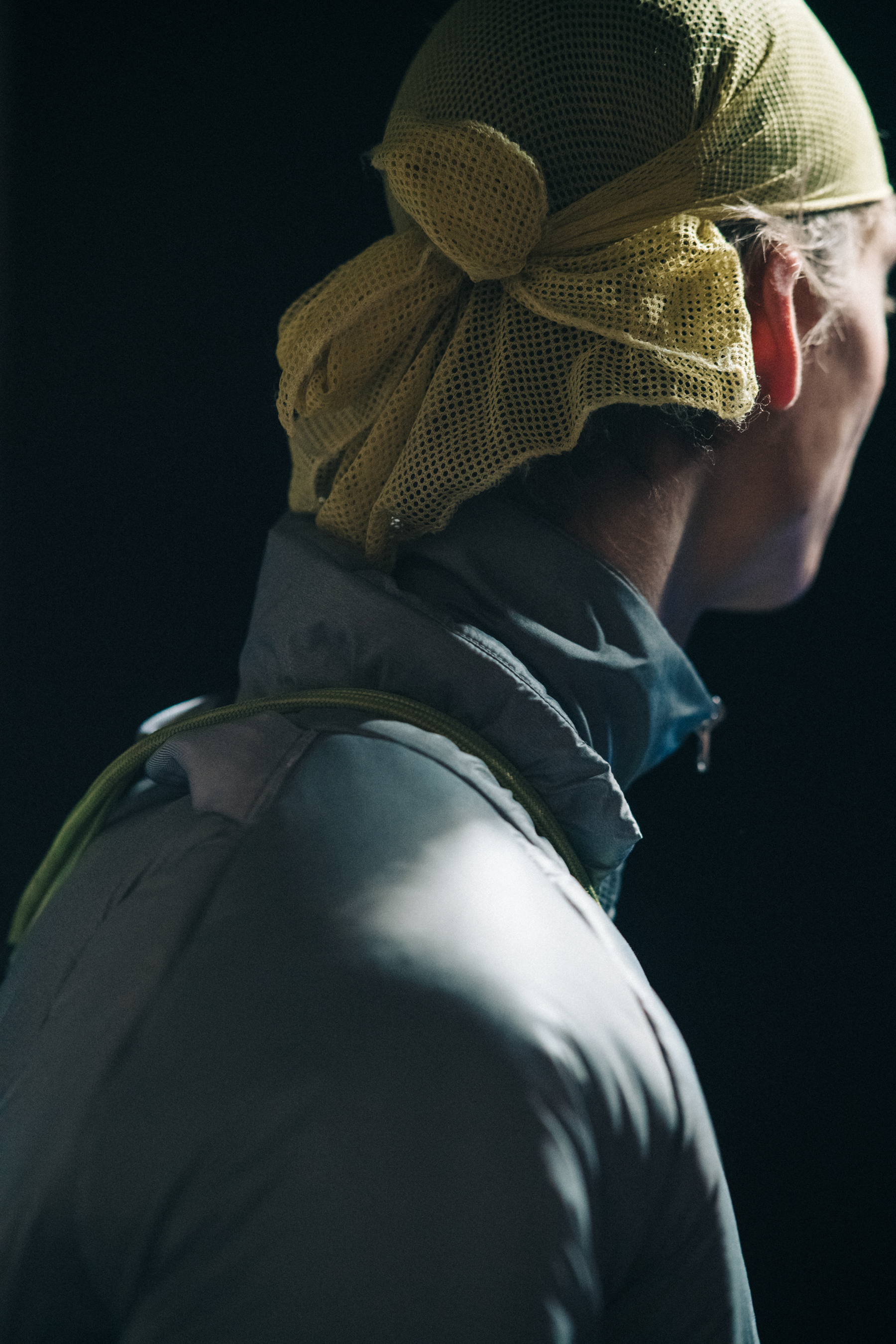 Model wearing yellow hair net backstage
