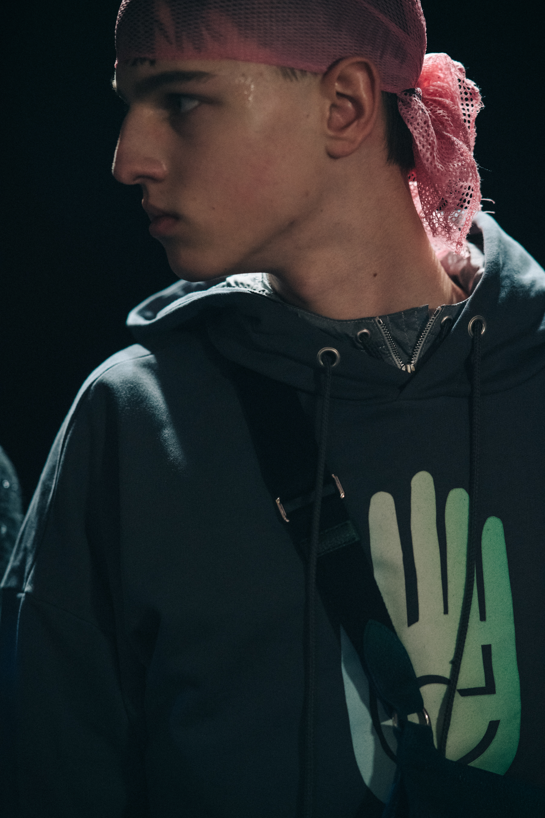 Model wearing pink hair net backstage