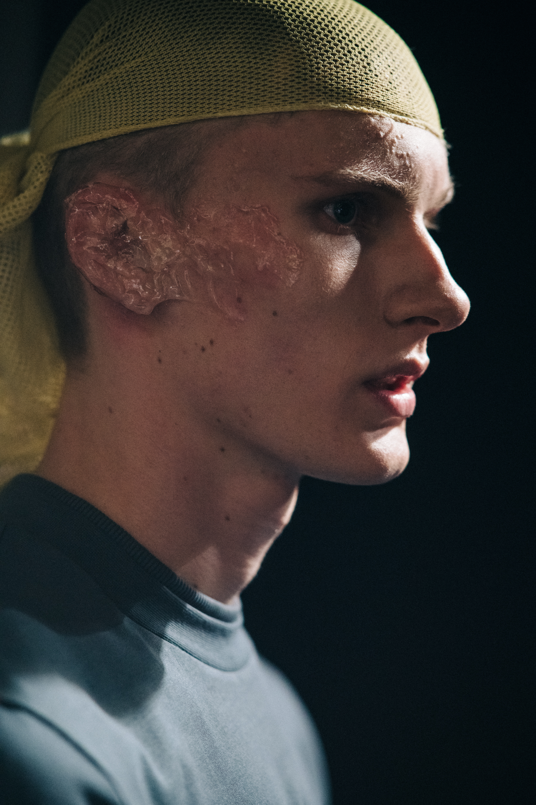 Model wearing yellow hair net backstage