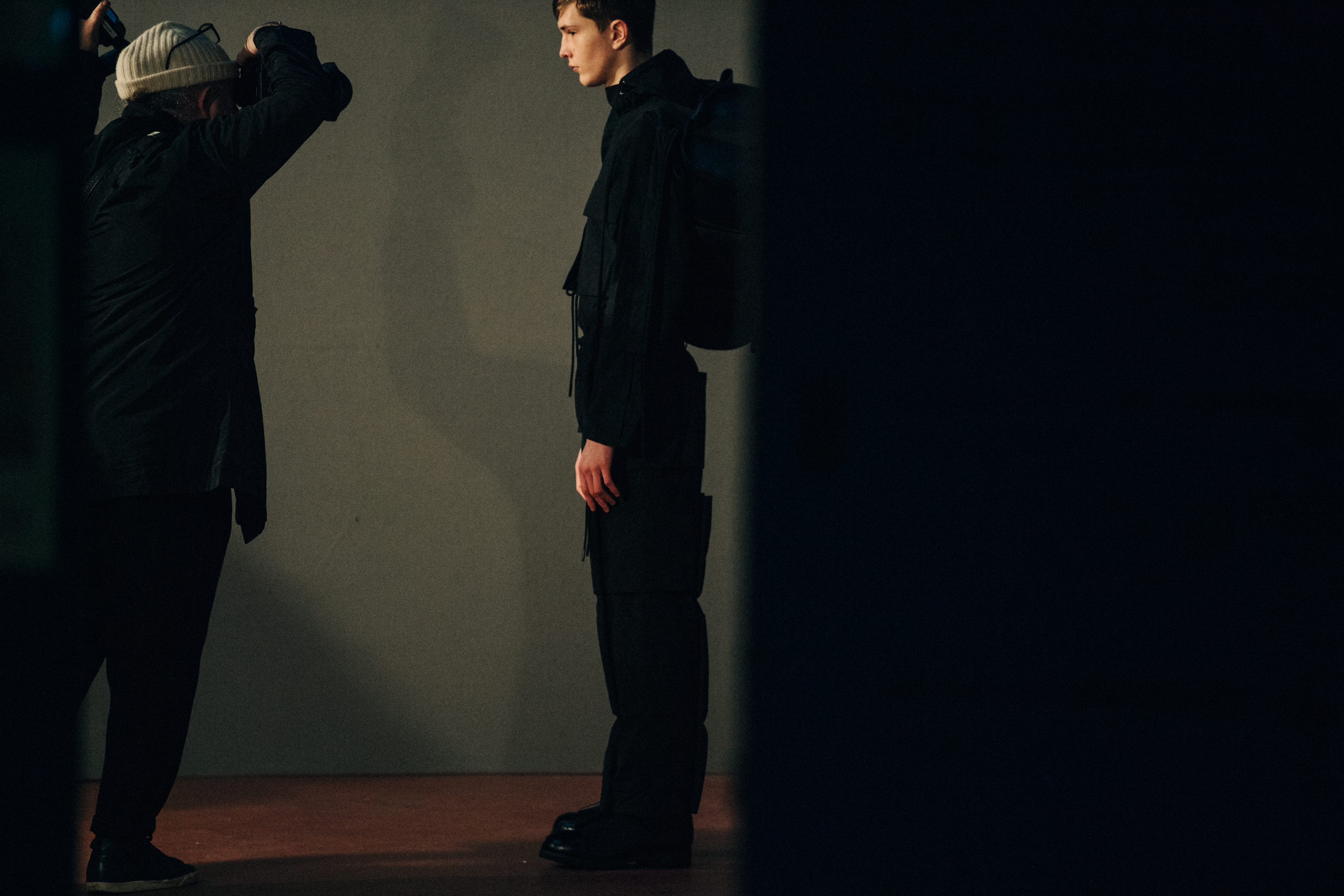 Model wearing black outfit backstage