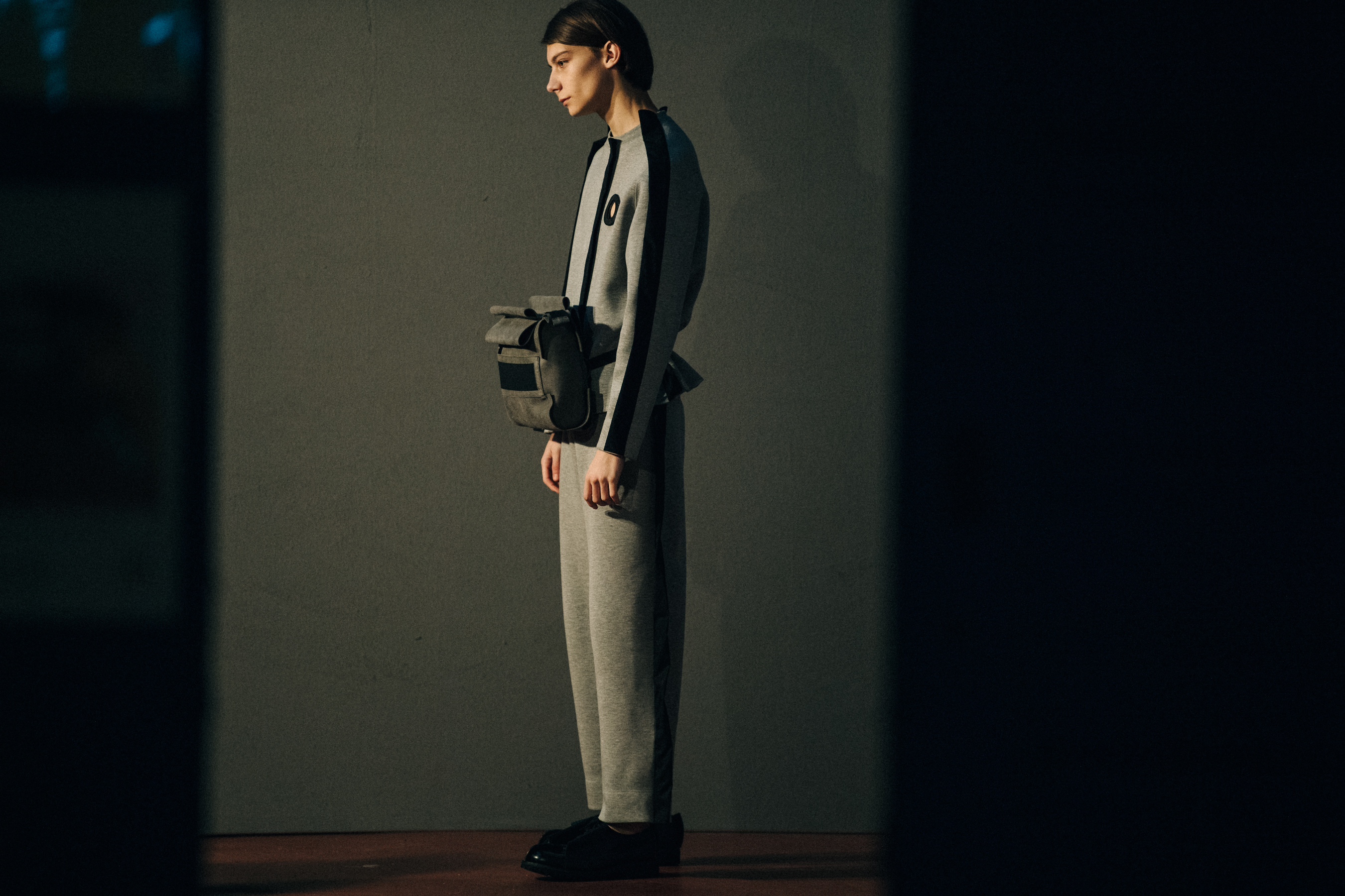 Model wearing grey outfit backstage