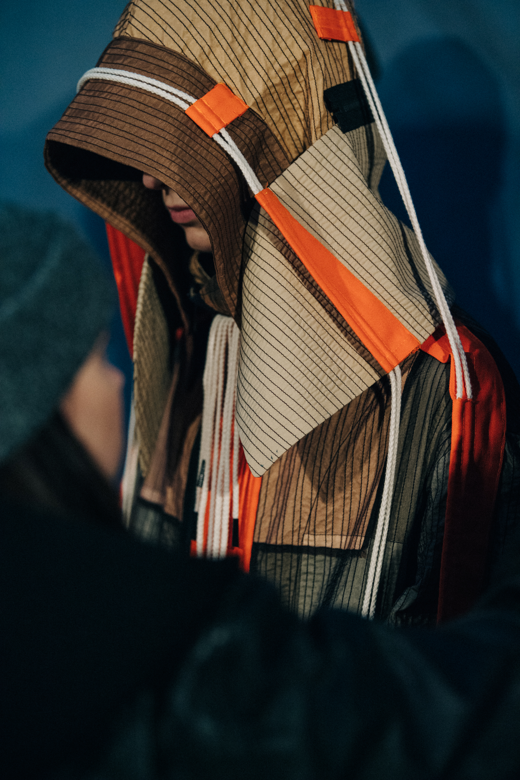 Model wearing Craig Green hood backstage