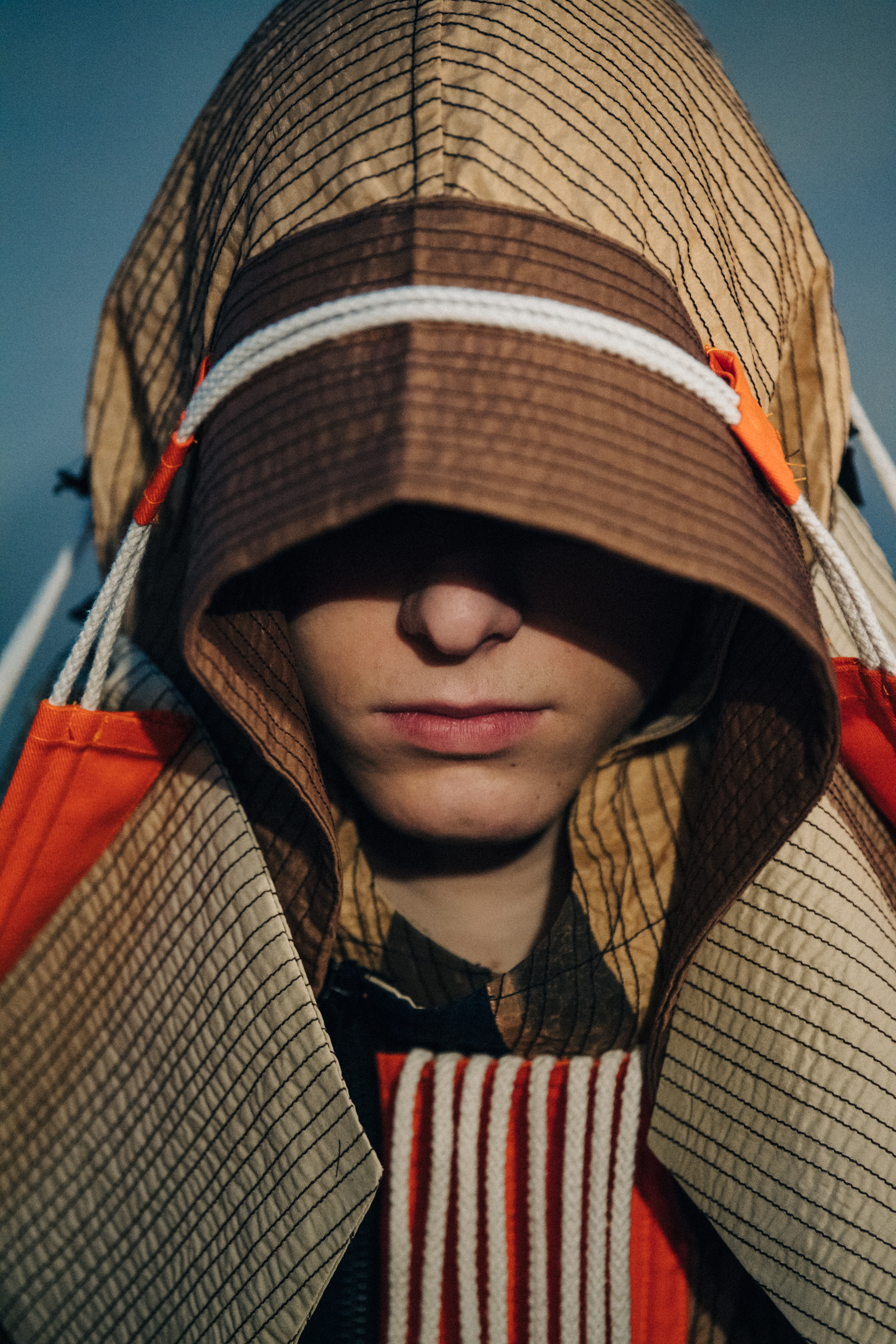 Portrait of model wearing Craig Green hood