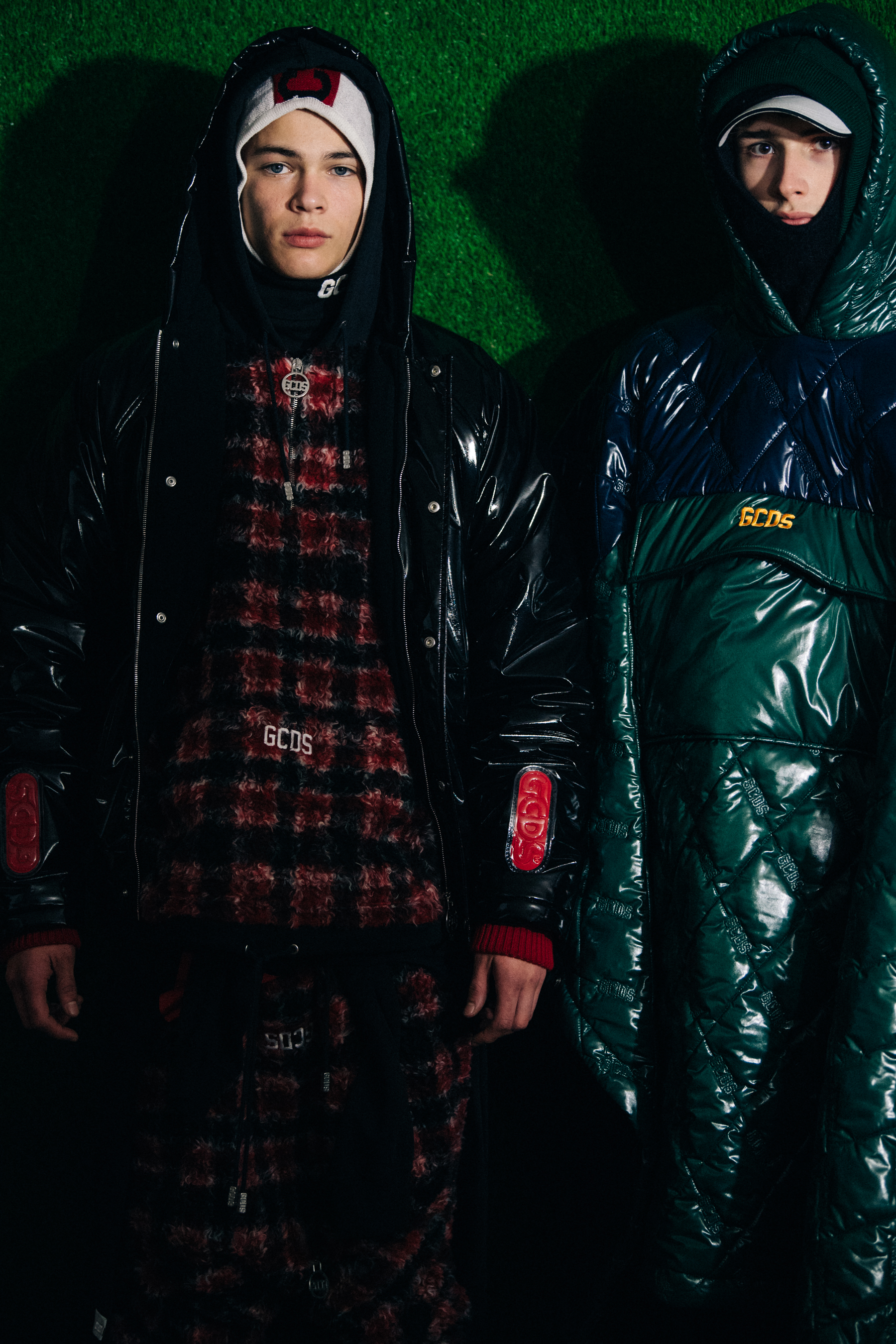 Two models wearing GCDS hoods and hats