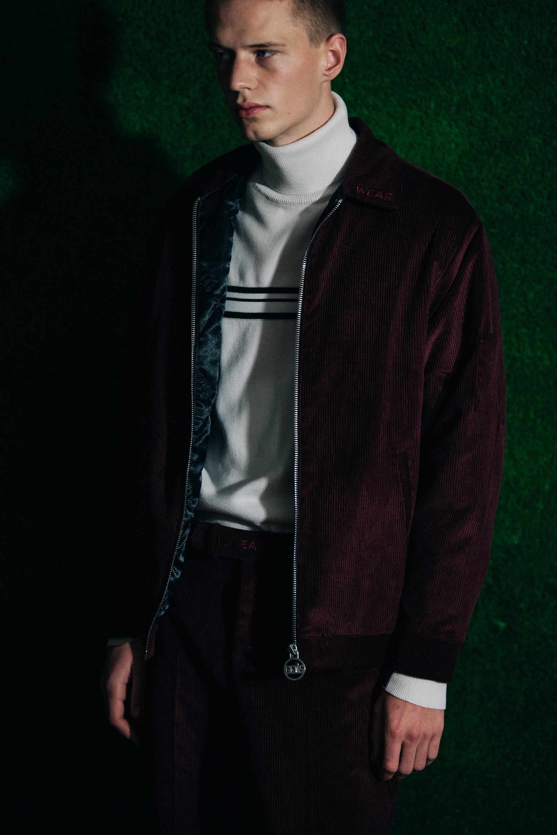 Model wearing burgundy GCDS jacket