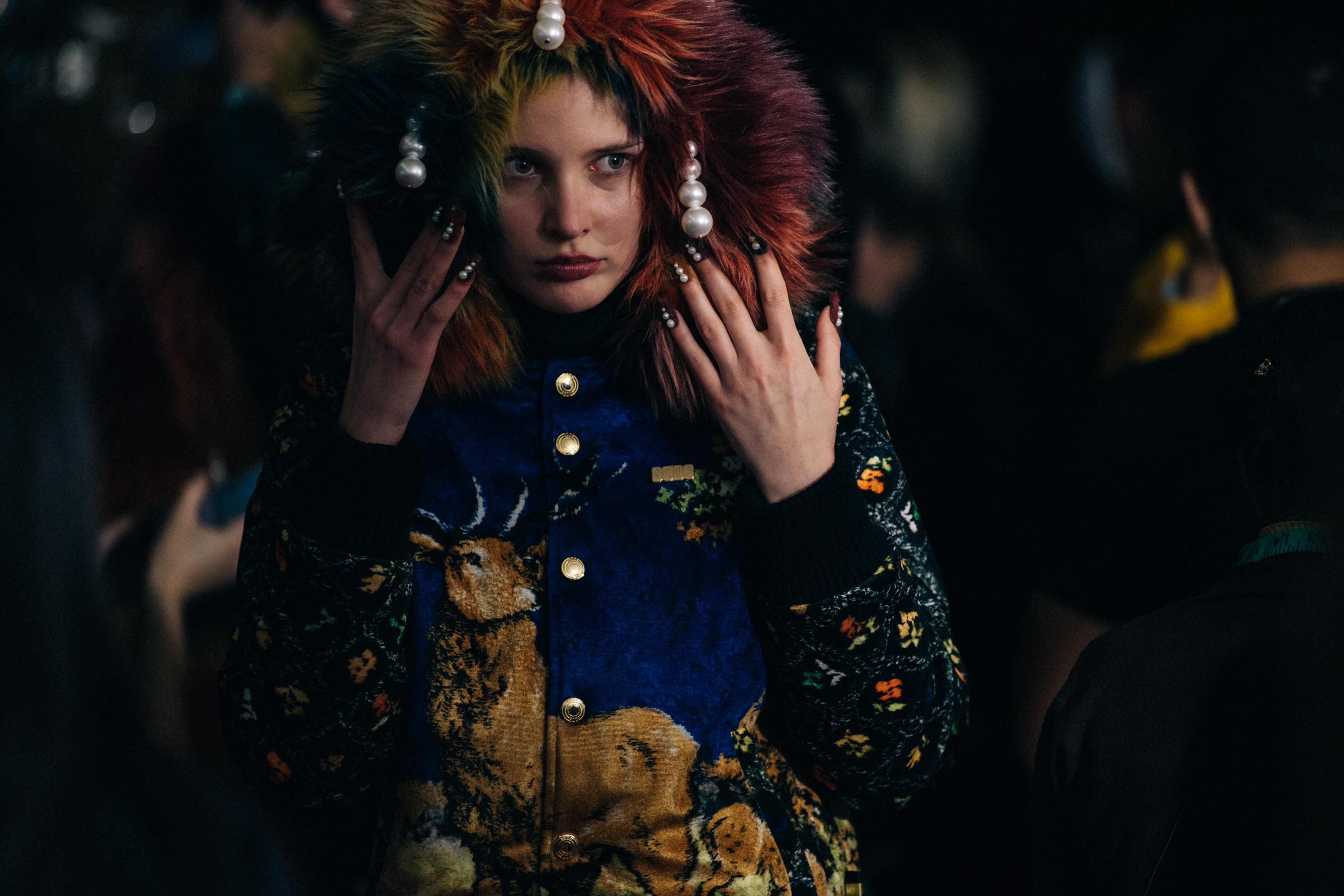 Model backstage wearing animal jumper