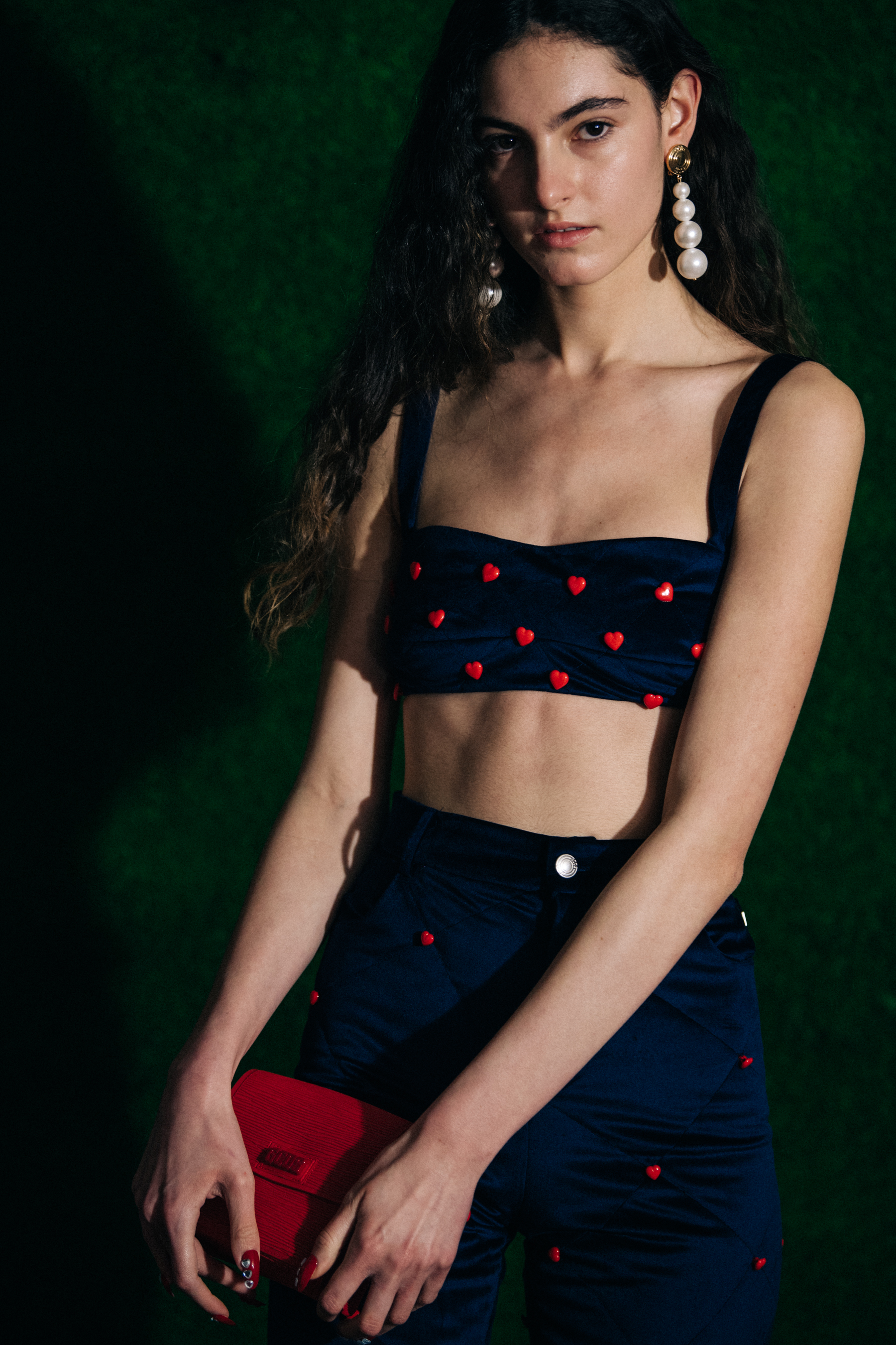 Model bakcstage wearing pearl earrings