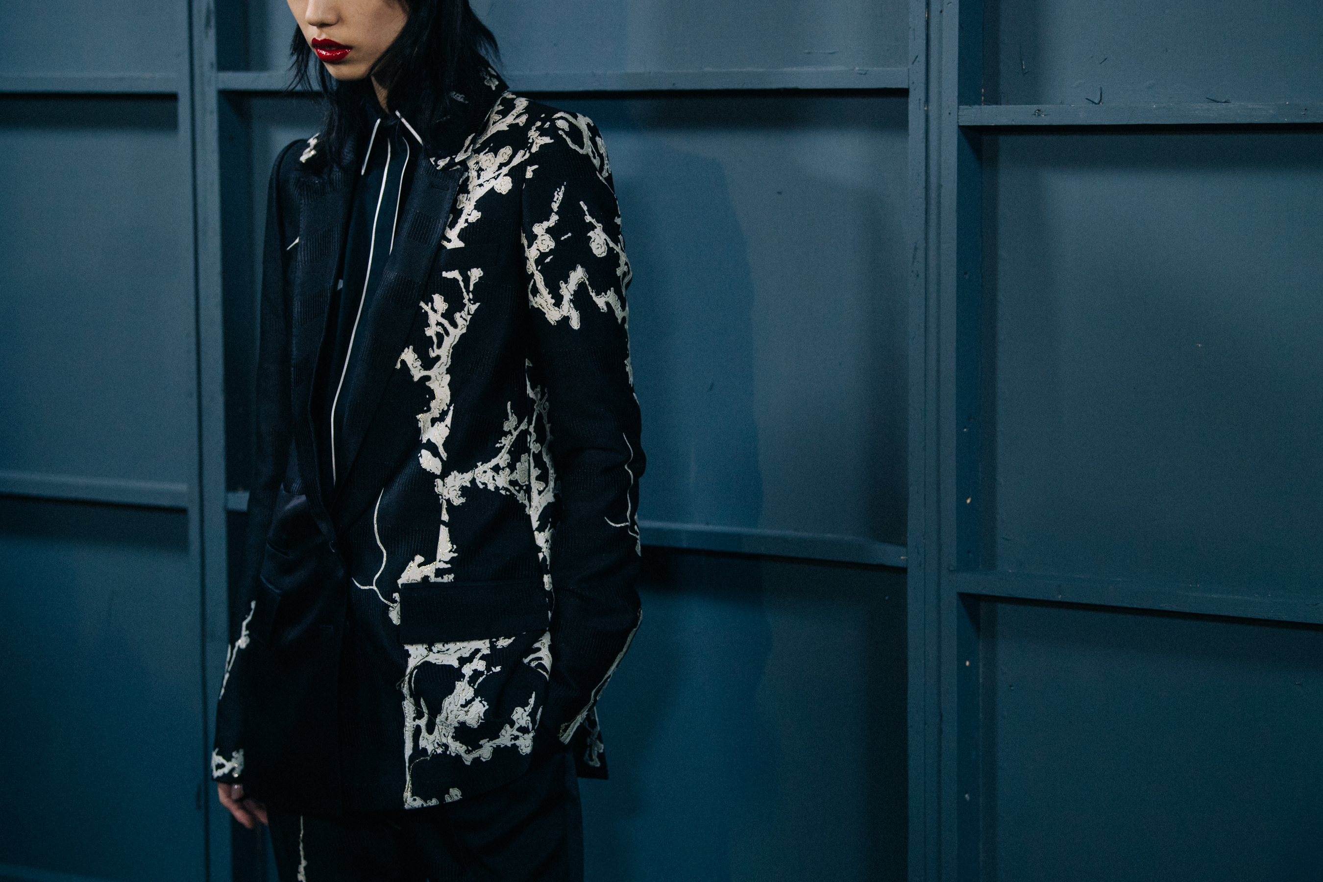 Model wearing suit jacket backstage