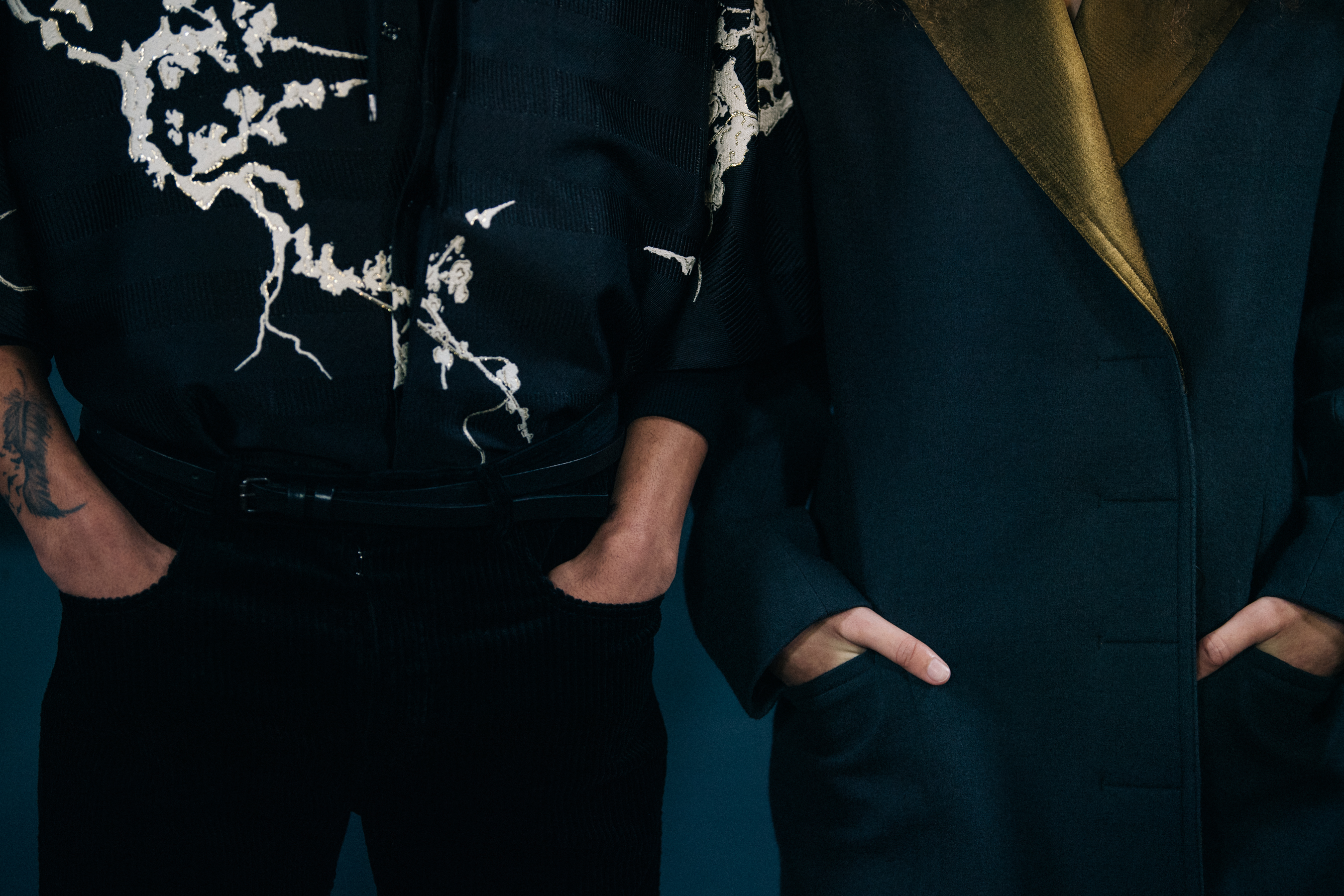 Models wearing black and gold outfits