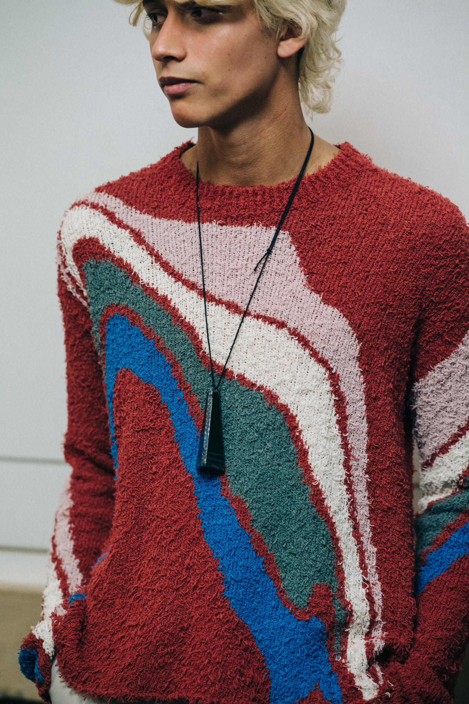 Model wearing red and blue backstage