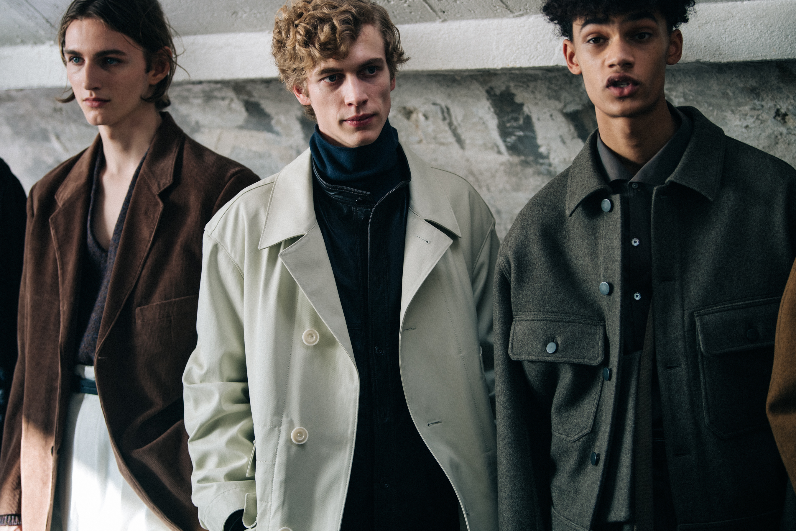 Three models backstage wearing Lemaire