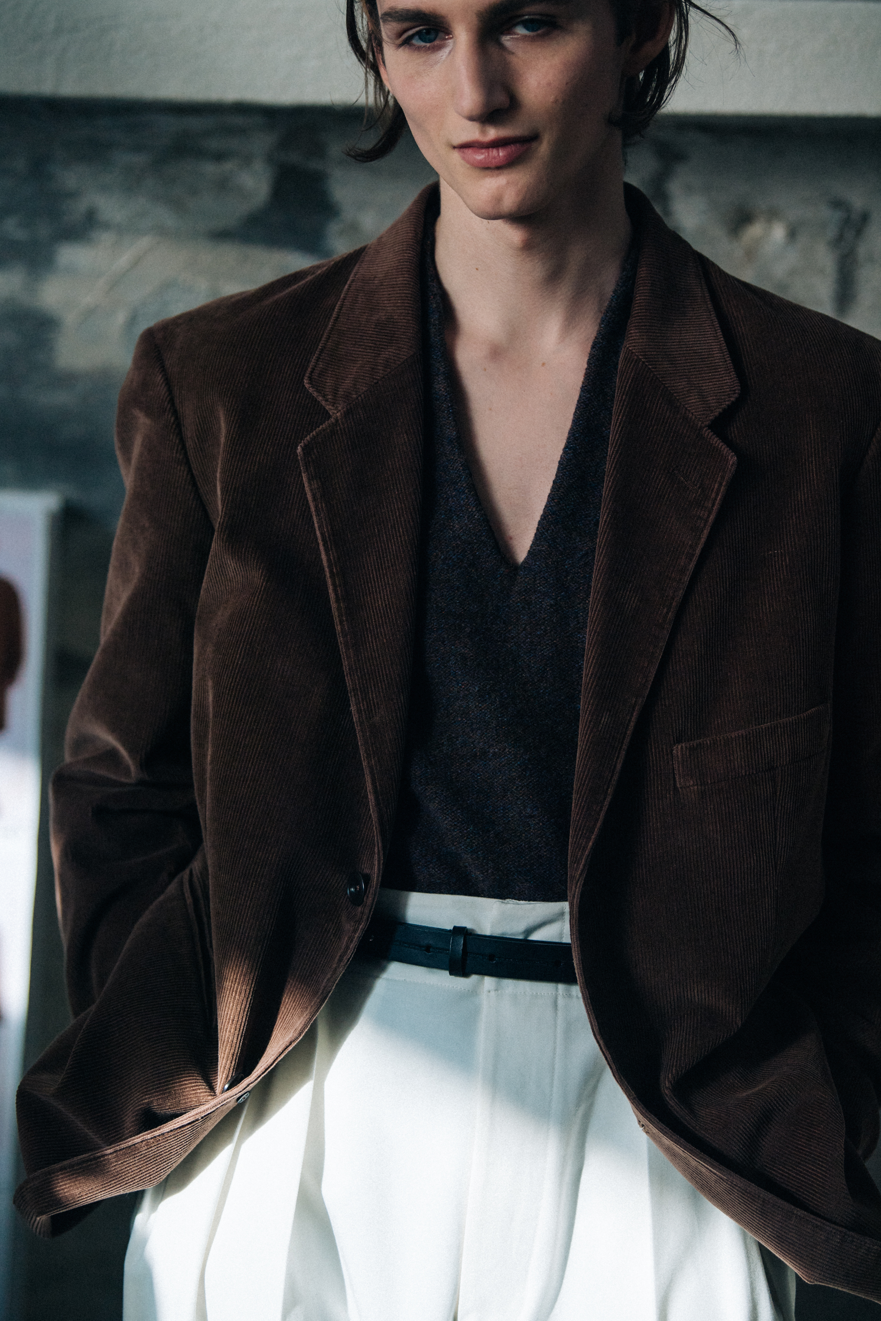 Model wearing brown and white outfit
