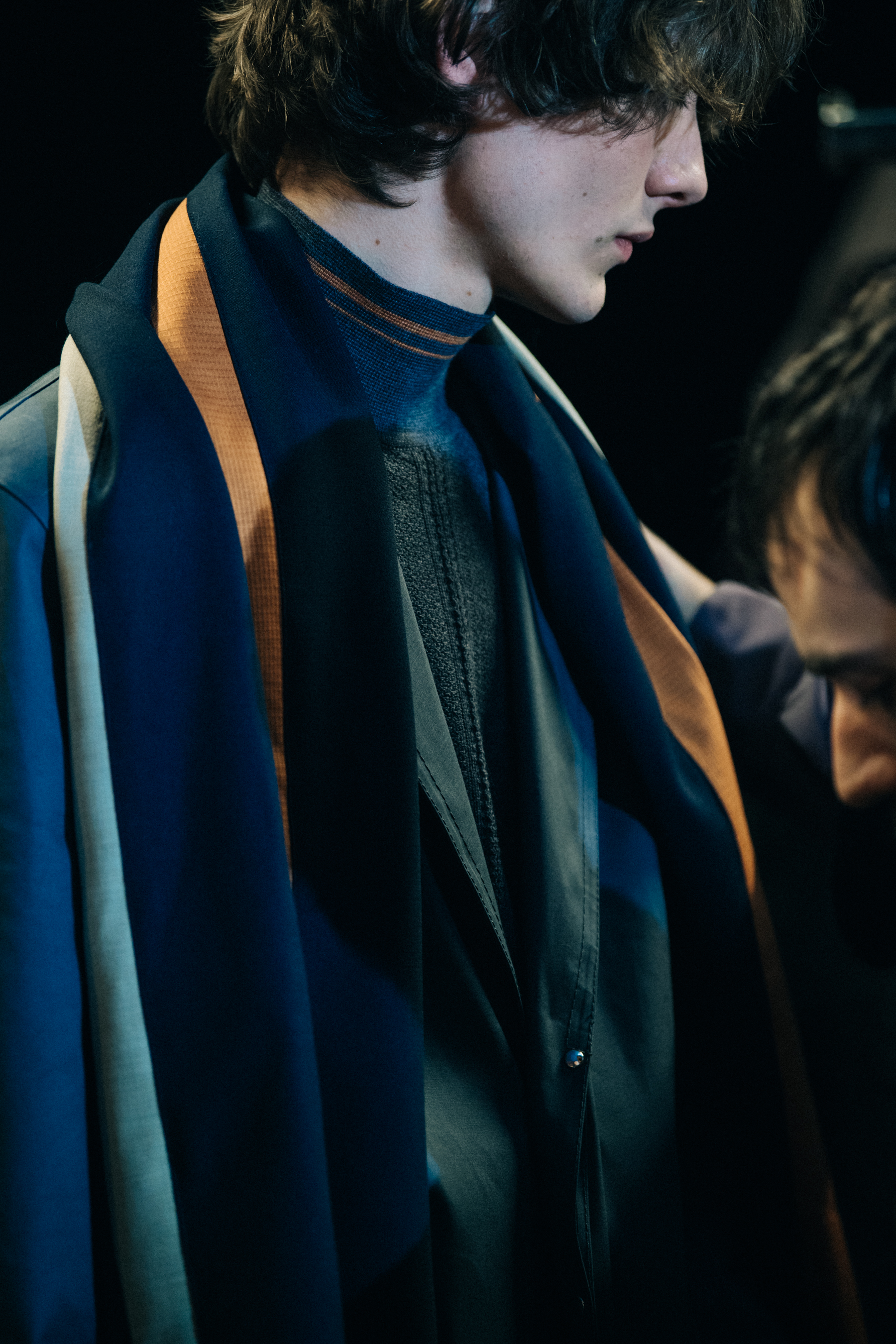 Model wearing colourful scarf backstage
