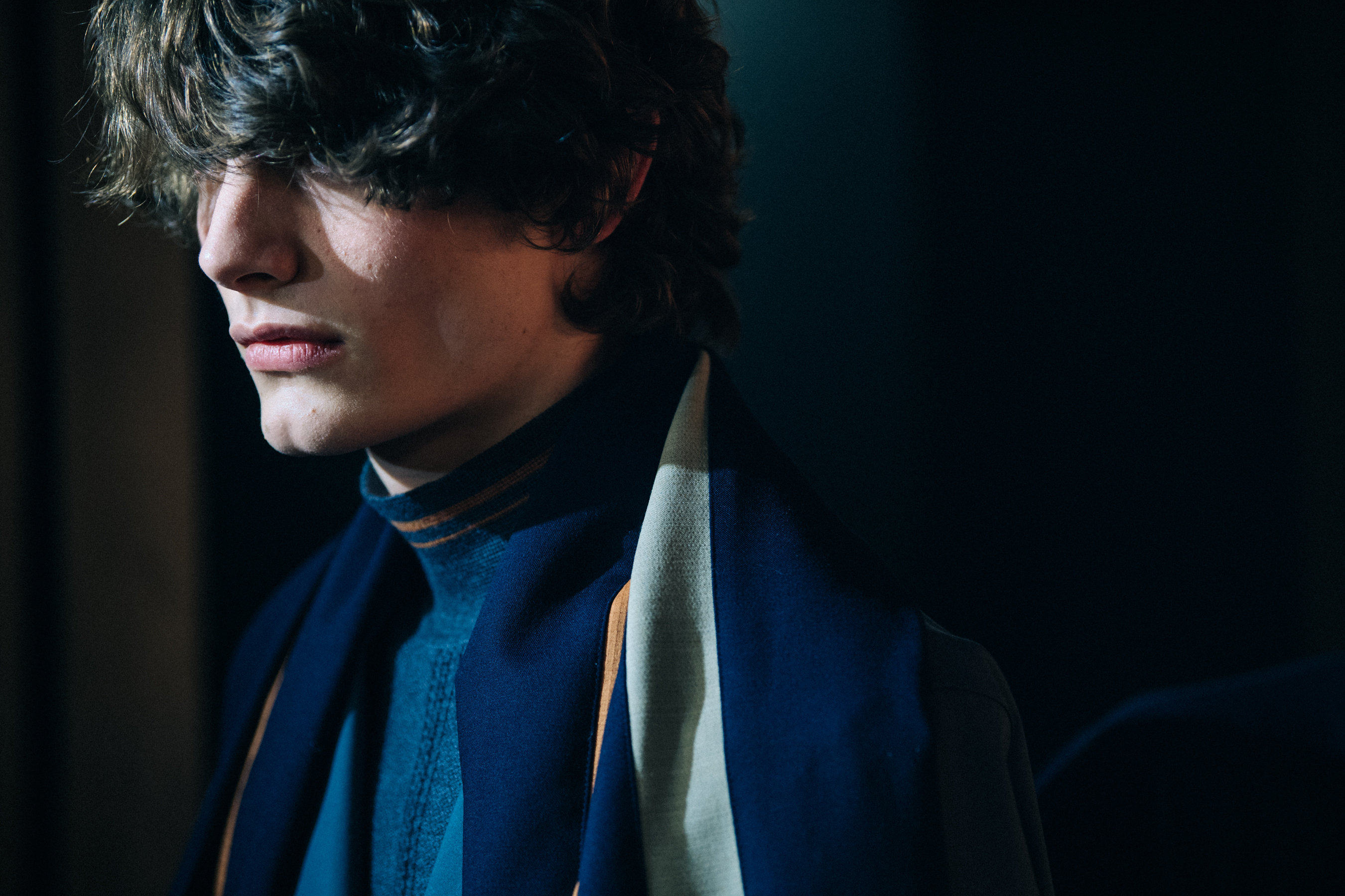Model wearing colourful scarf backstage