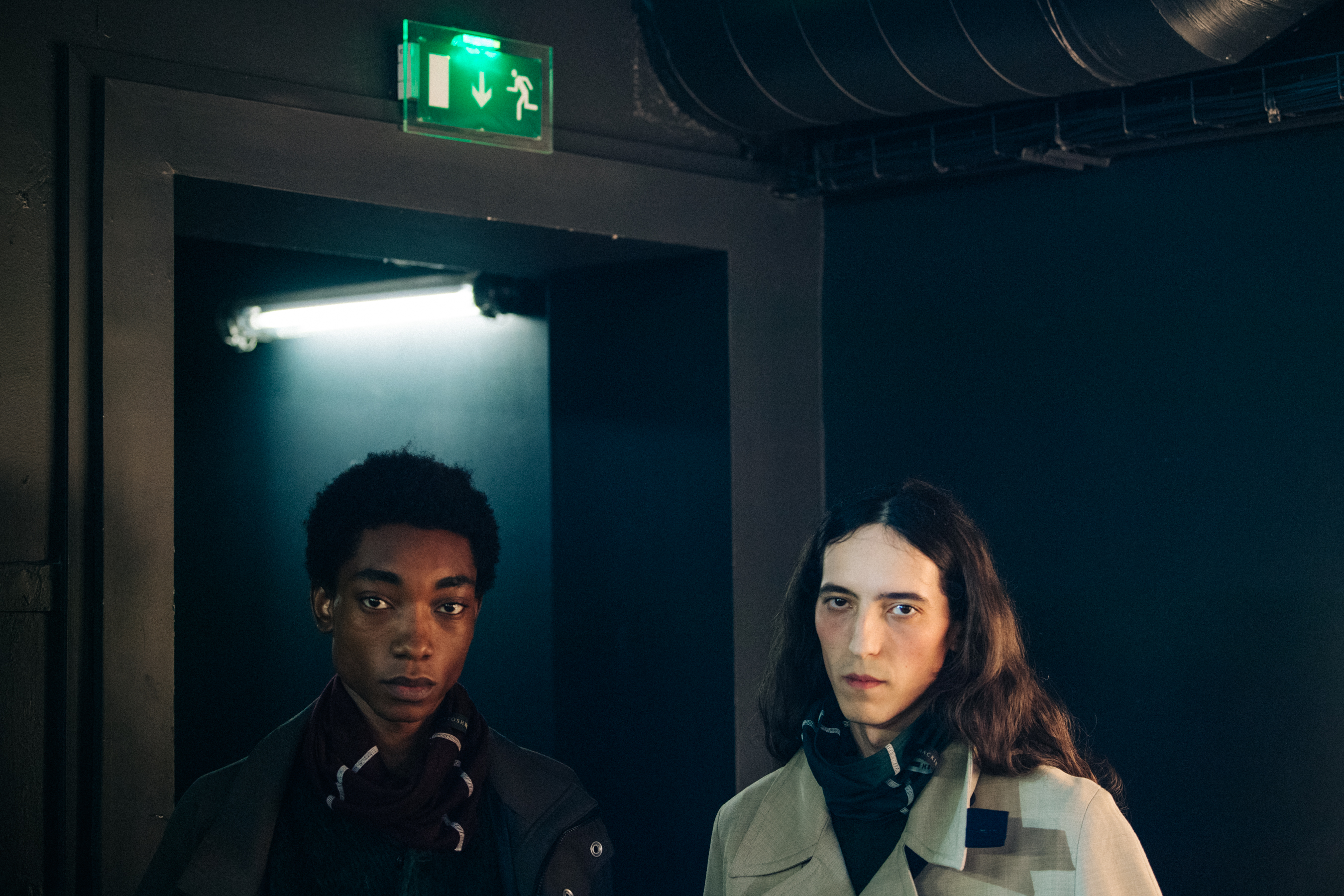 Two models wearing button jackets