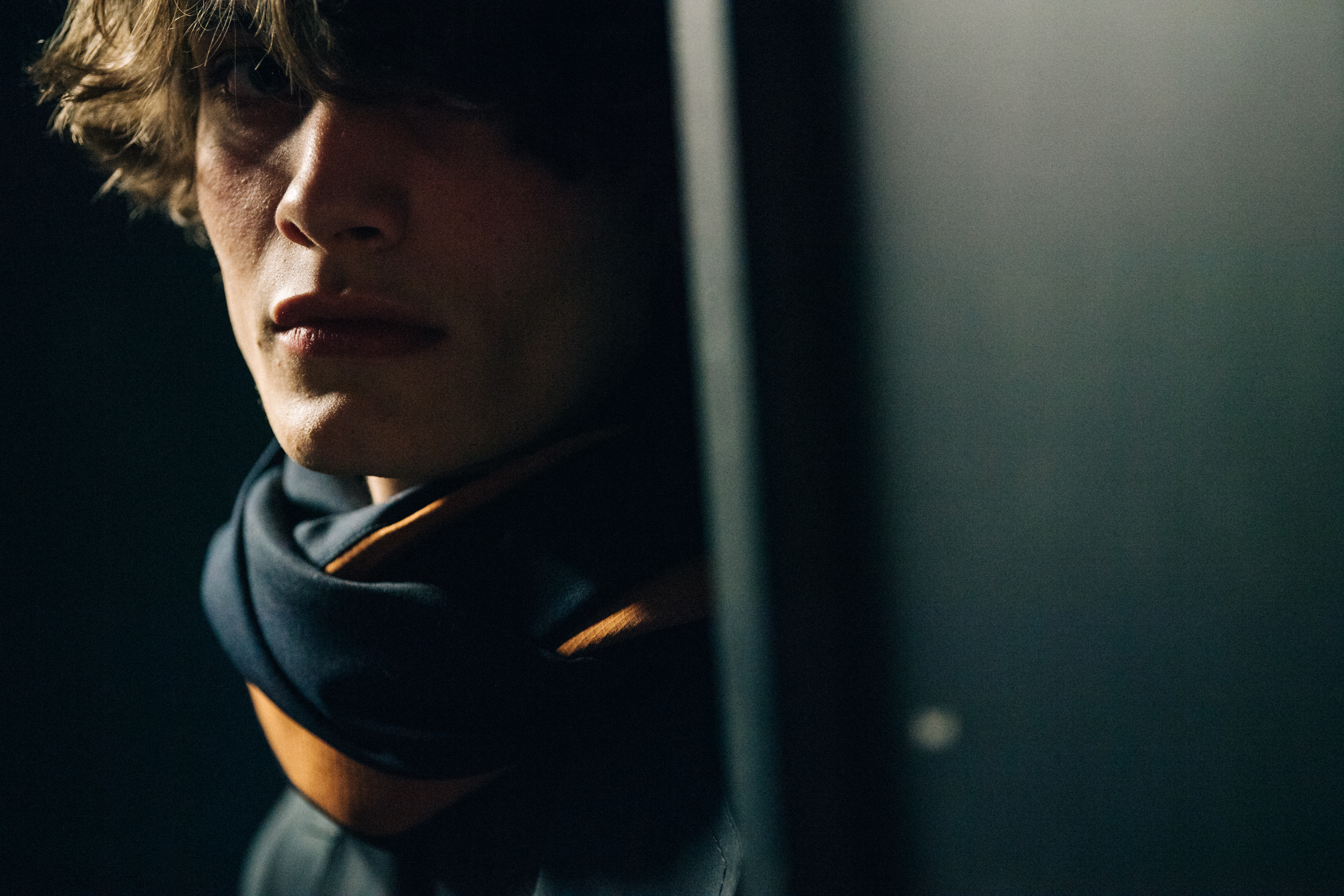 Model wearing grey and orange scarf