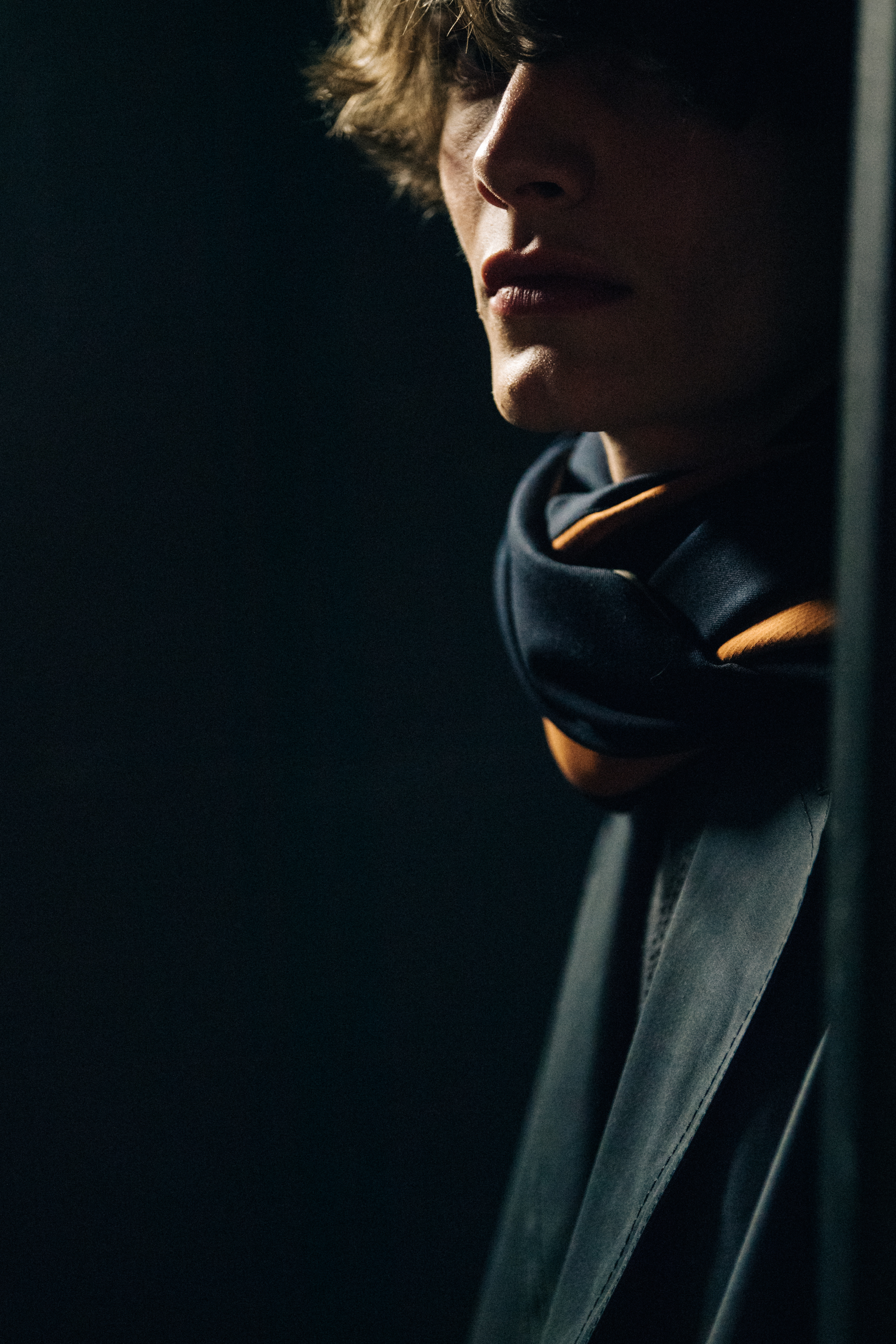 Model wearing grey and orange scarf