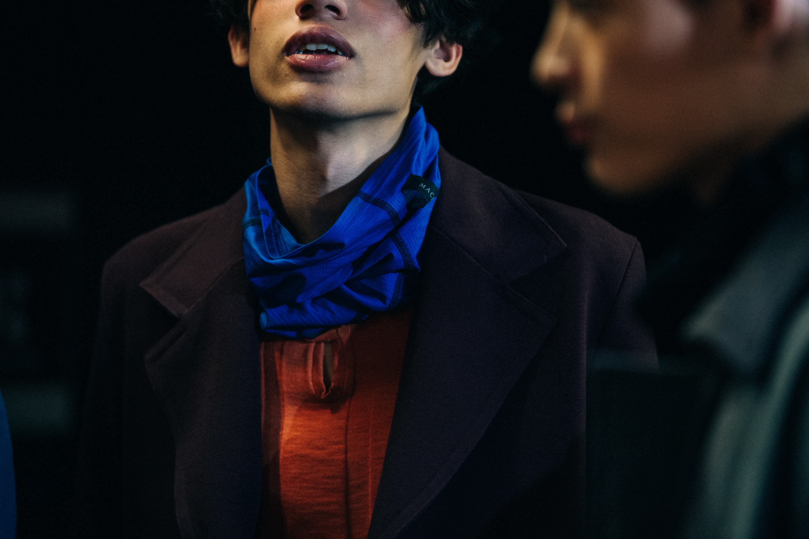 Model wearing blue scarf backstage