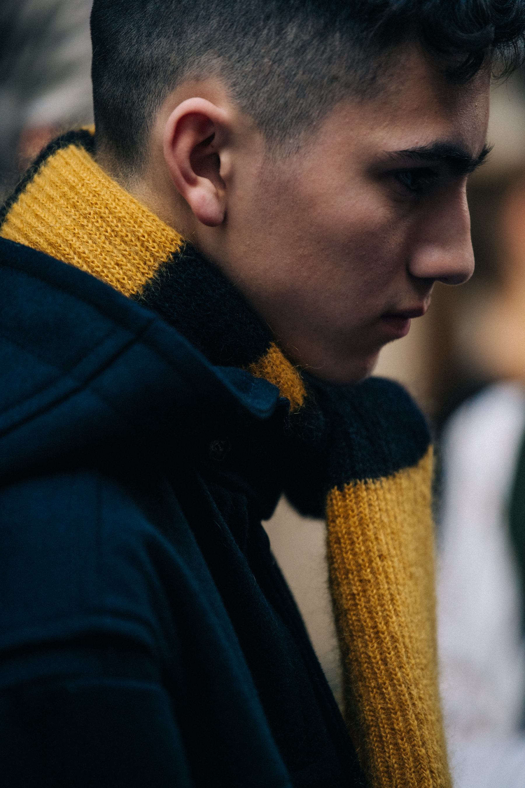 Model wearing yellow and black scarf backstage