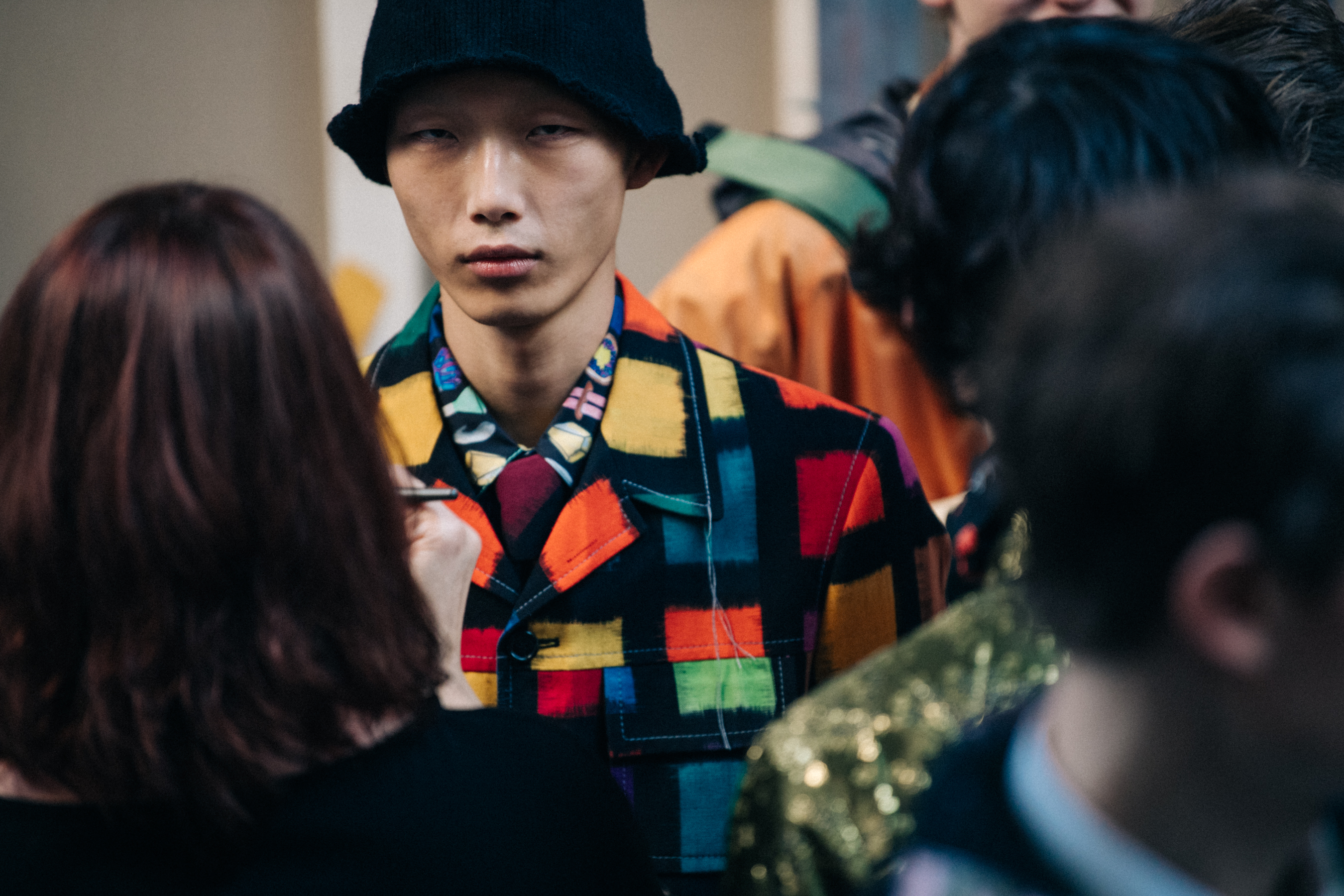 Su Min Kim wearing colourful suit backstage