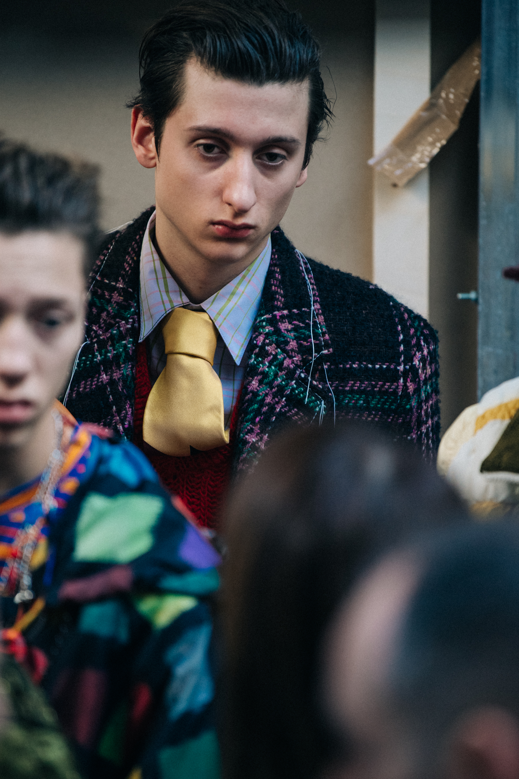 Model backstage wearing colourful suit