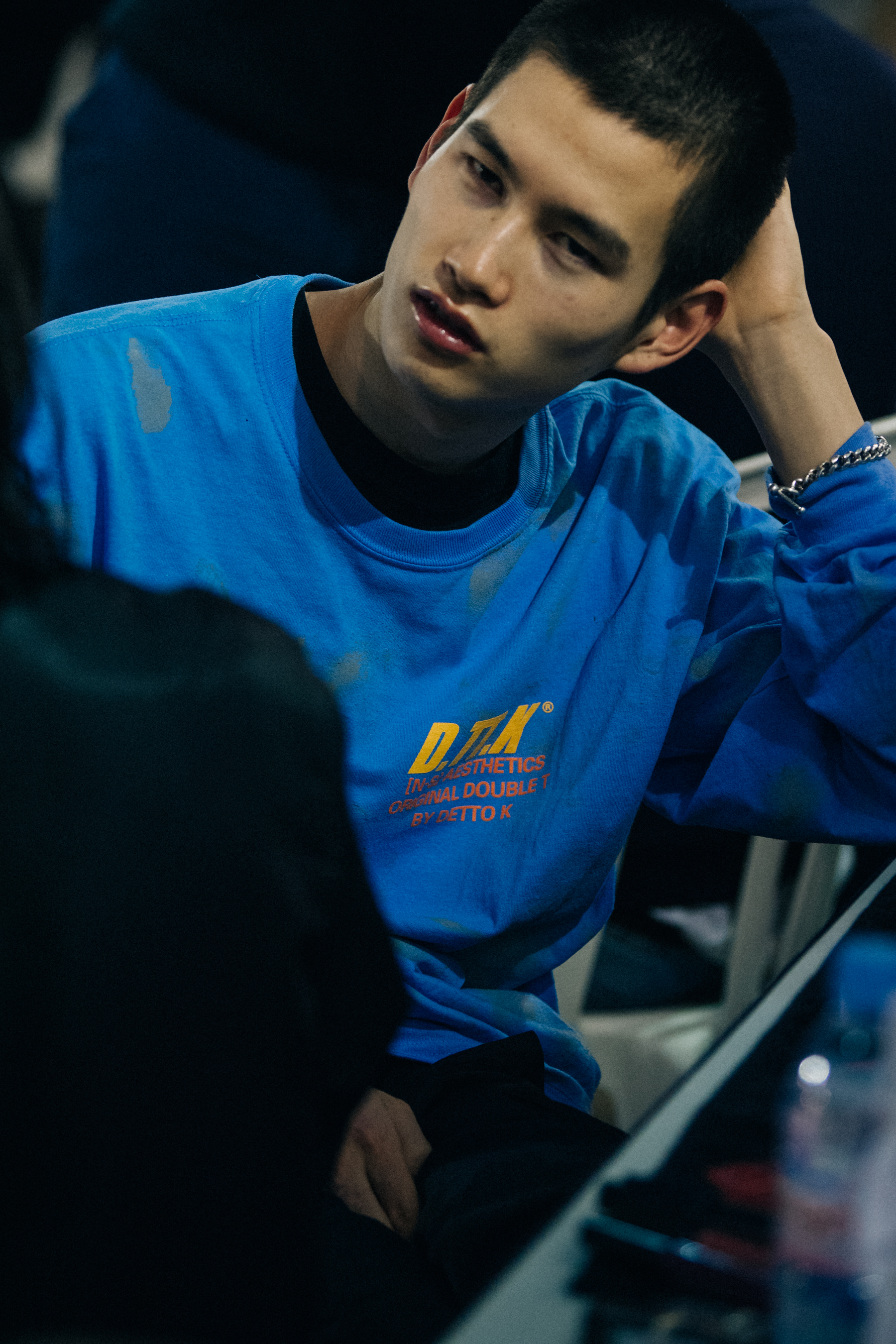 Model wearing blue tee shirt backstage